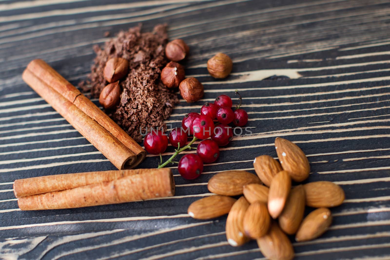 Nuts, cinnamon, candied fruits, chocolate chips lie on the texture table