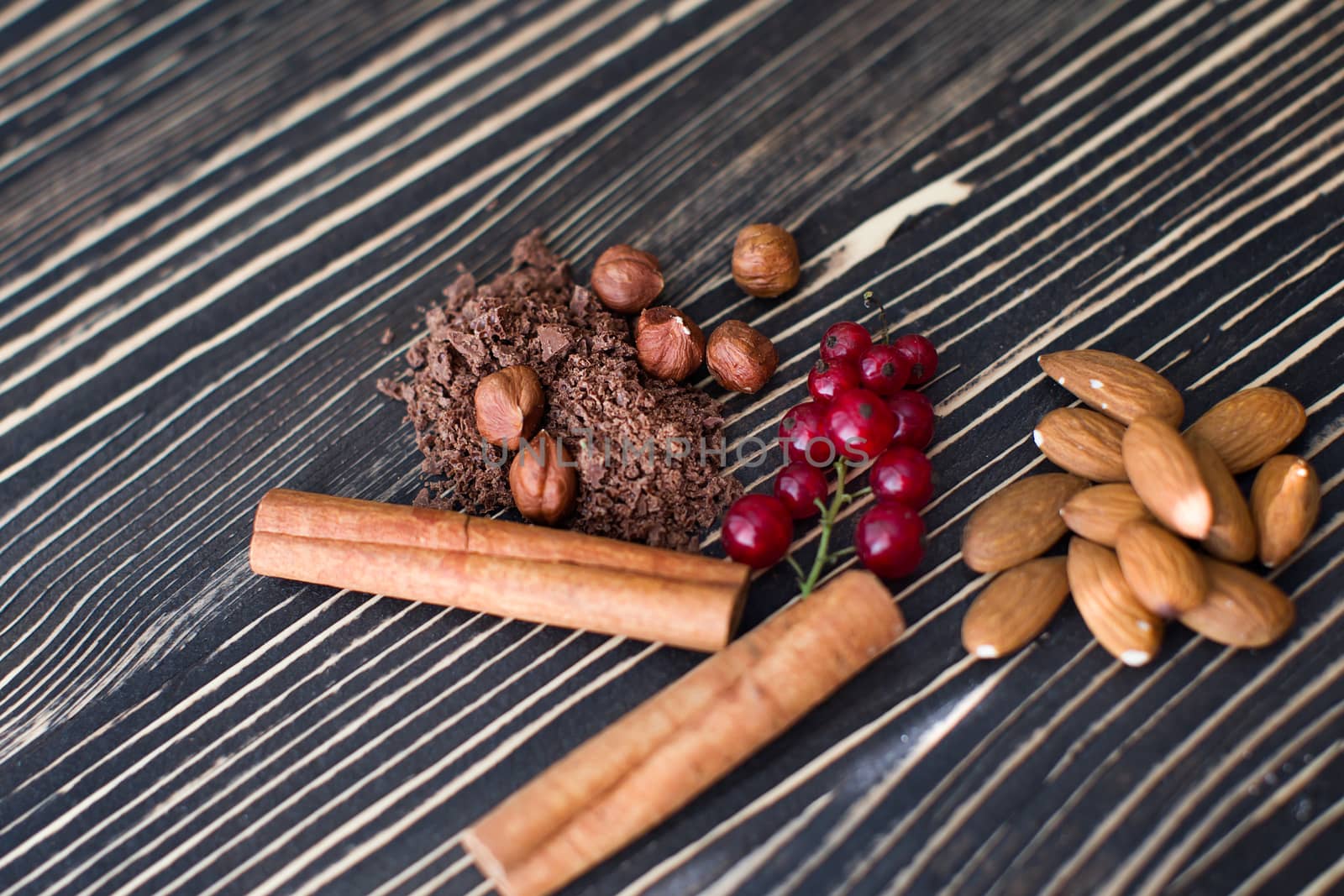 Nuts, cinnamon, candied fruits, chocolate chips lie on the texture table