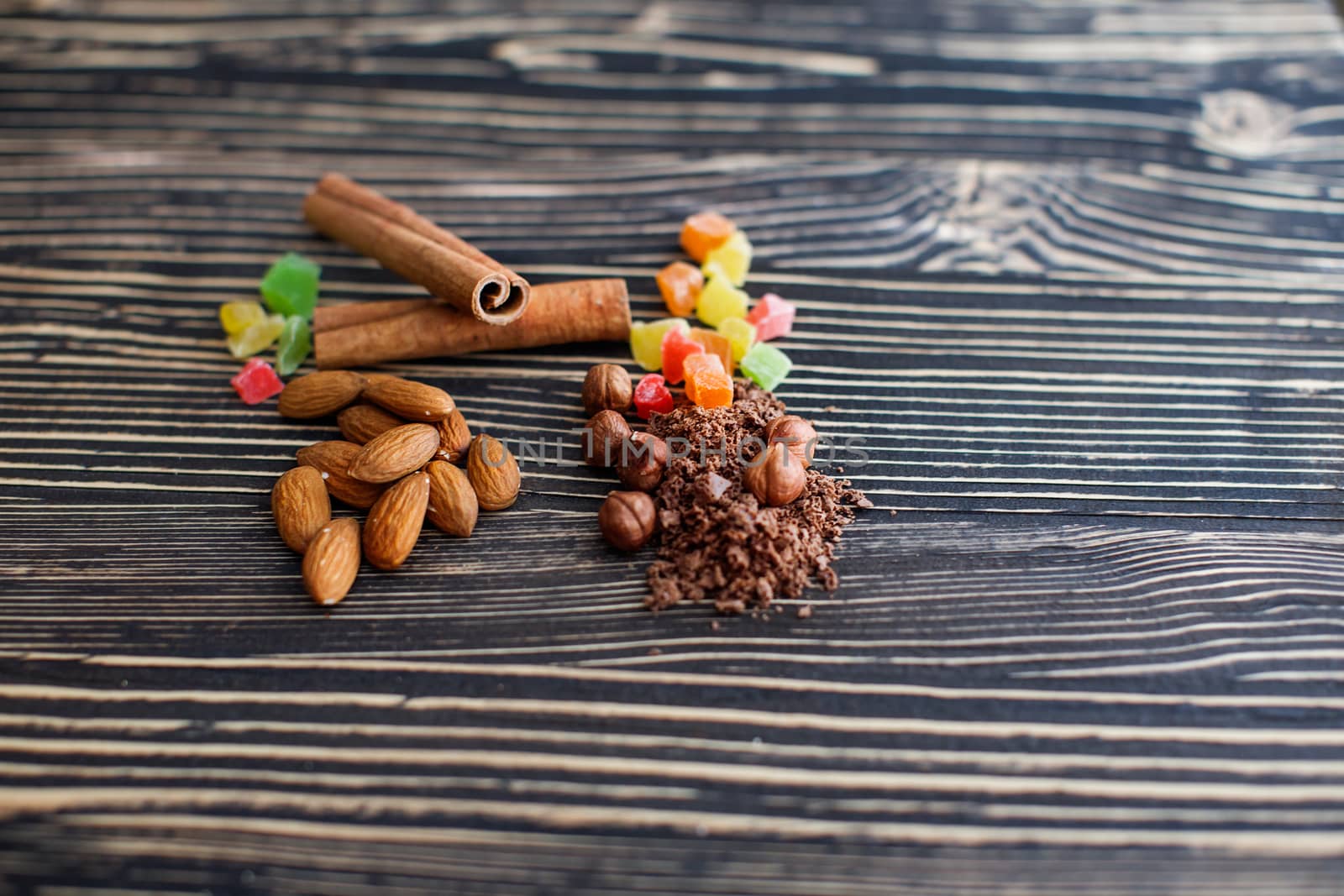 Chips of chocolate and nuts on textured board by lanser314