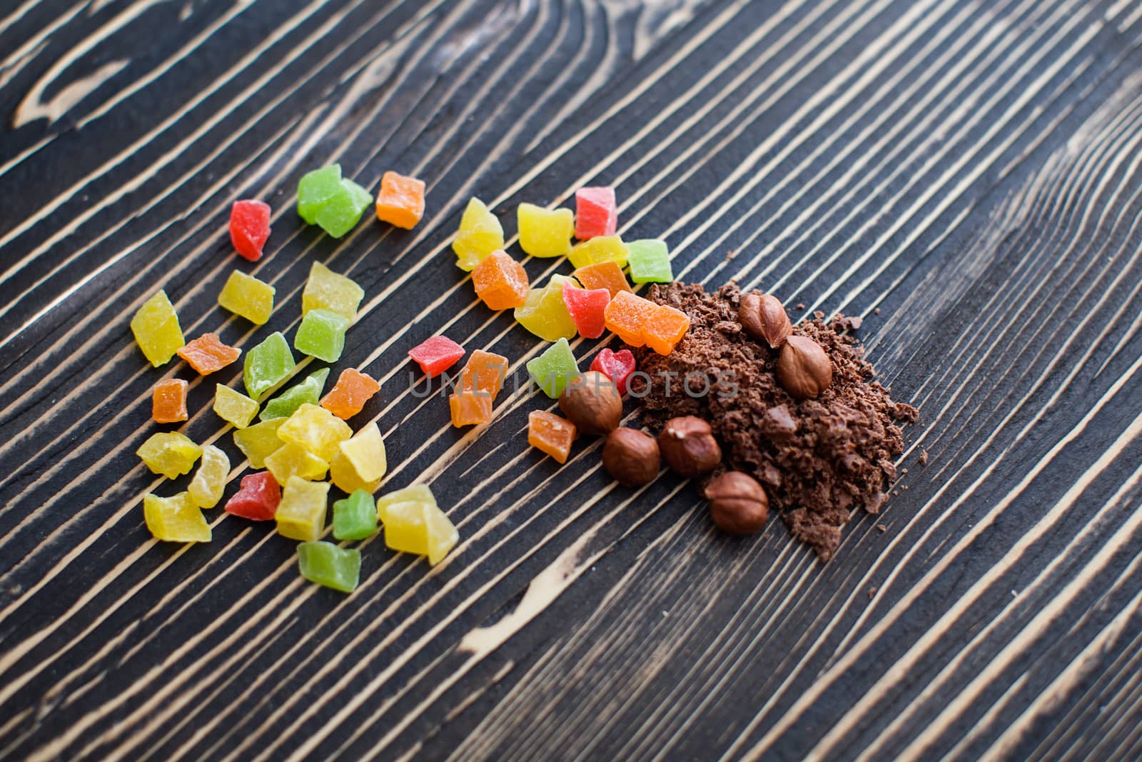 Nuts, cinnamon, candied fruits, chocolate chips lie on the texture table