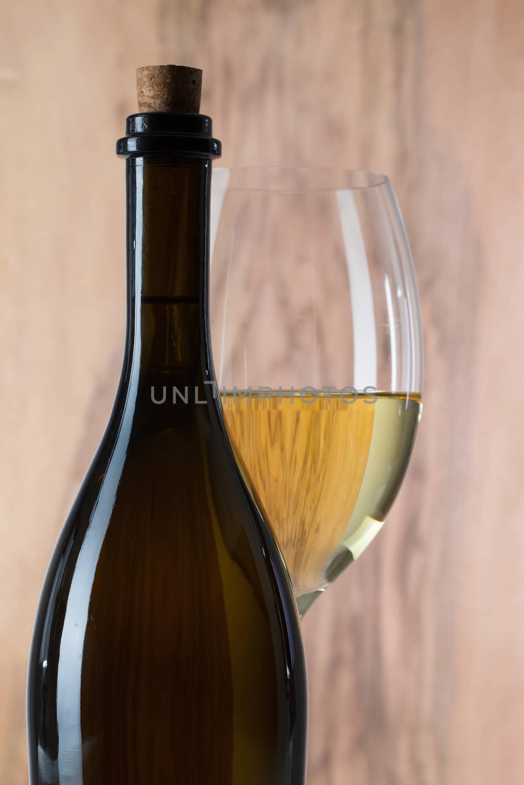 Detail of glass and bottle of white wine