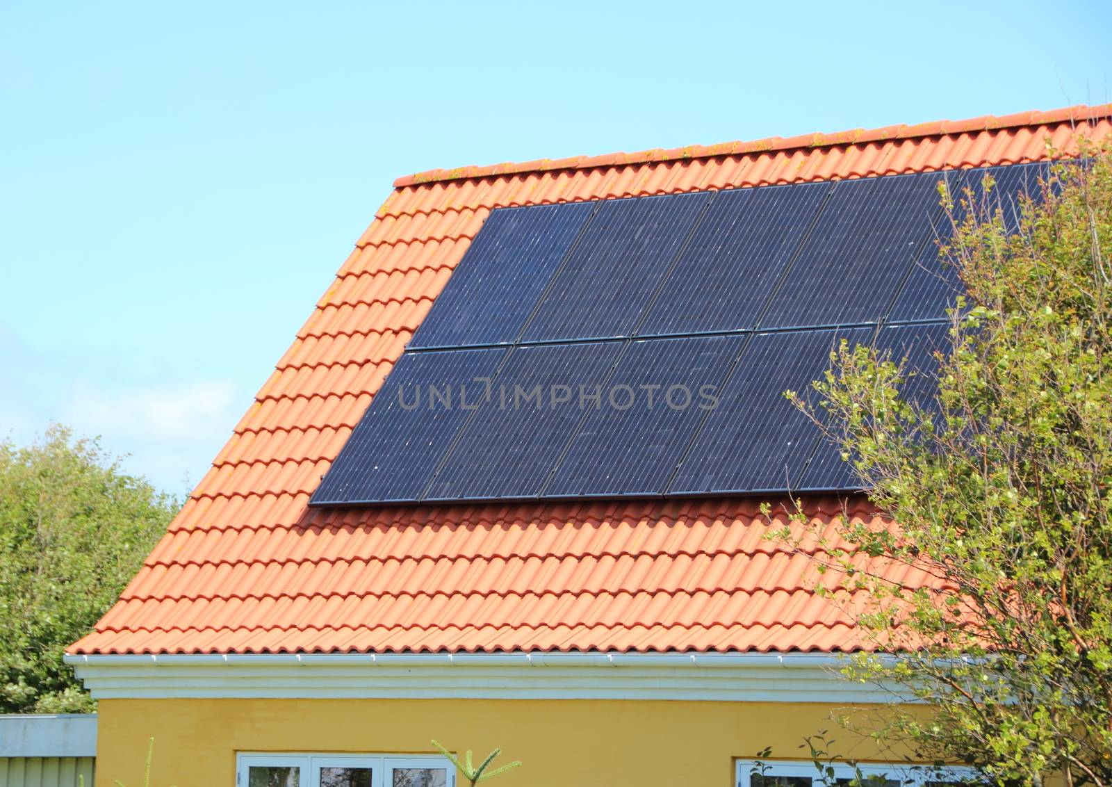Solar panel on House Roof with Red Tiles Saving Electricity