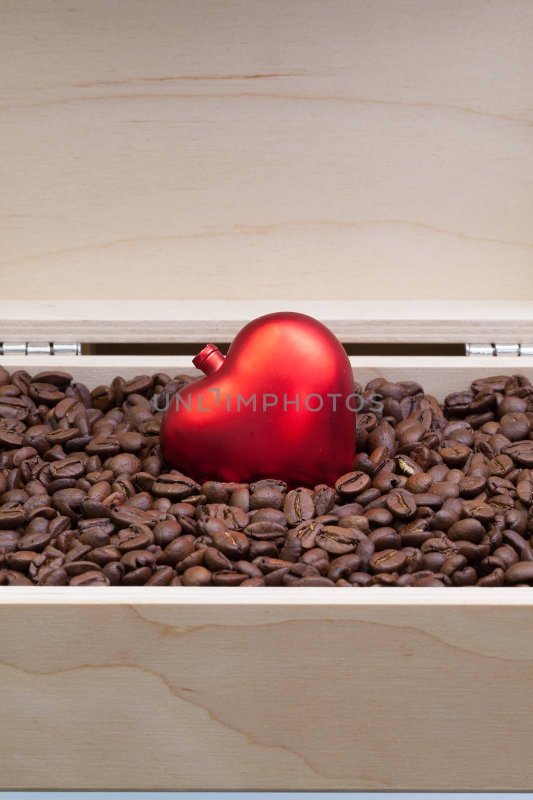 Coffee beans and red heart in an open wooden box