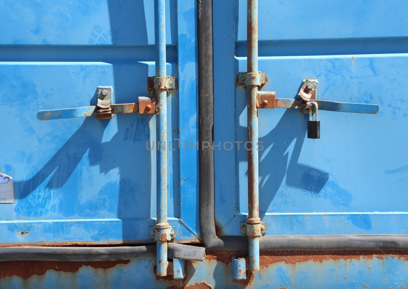 Rusty Lock Mechanism on Blue Container Front Closeup