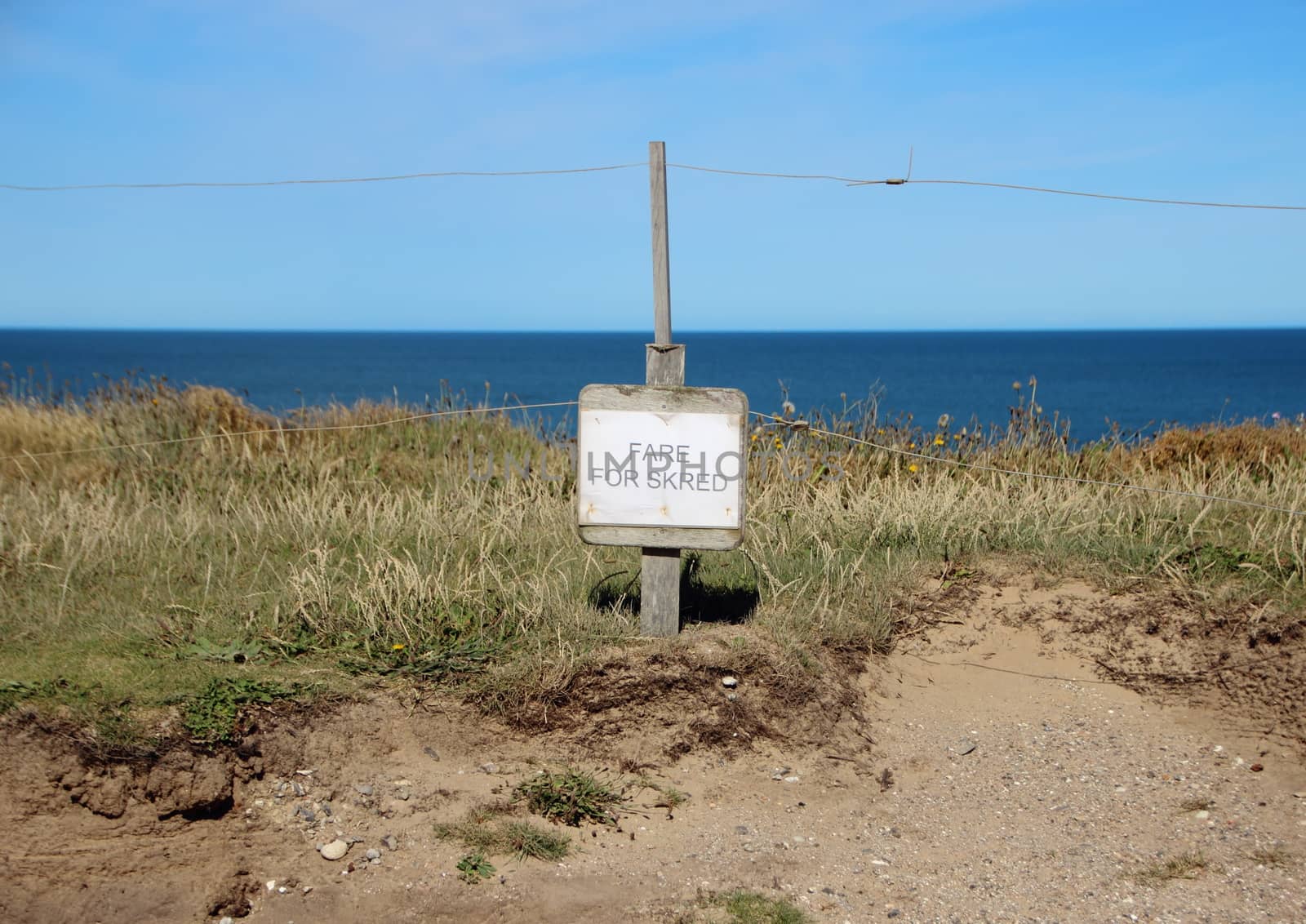 Danish Sign at Edge of Cliff warning of Erosion by HoleInTheBox