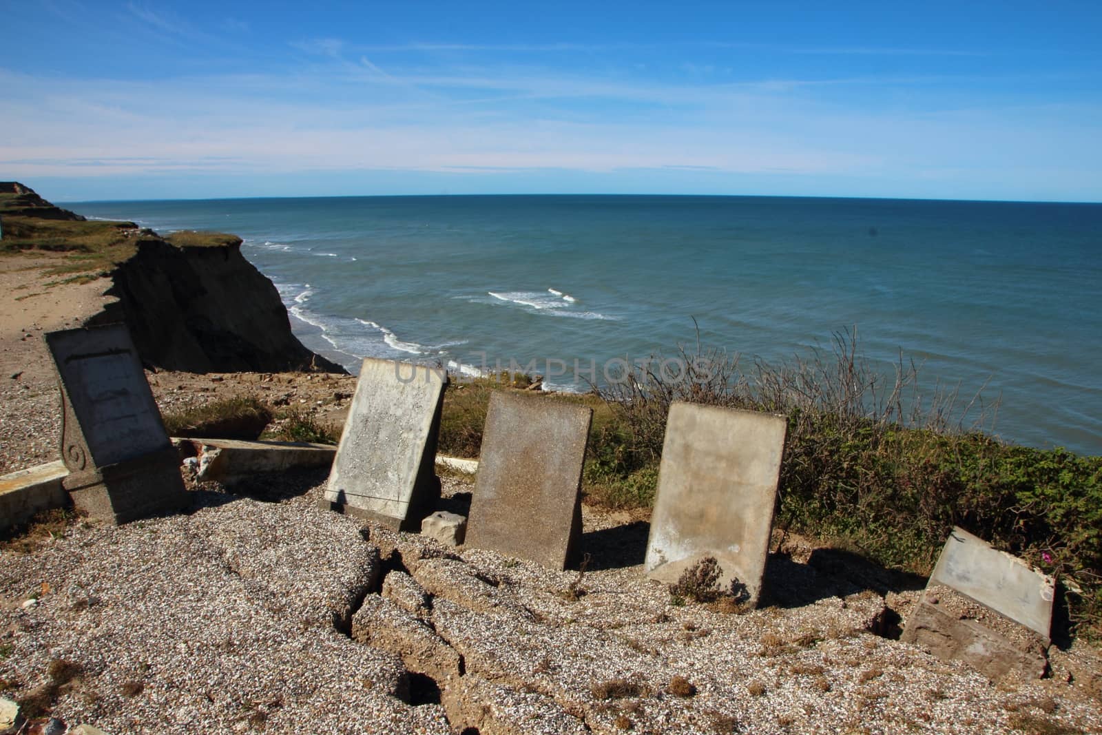 Ancient Headstones at Edge of Cliff with Erosion Cracks by HoleInTheBox