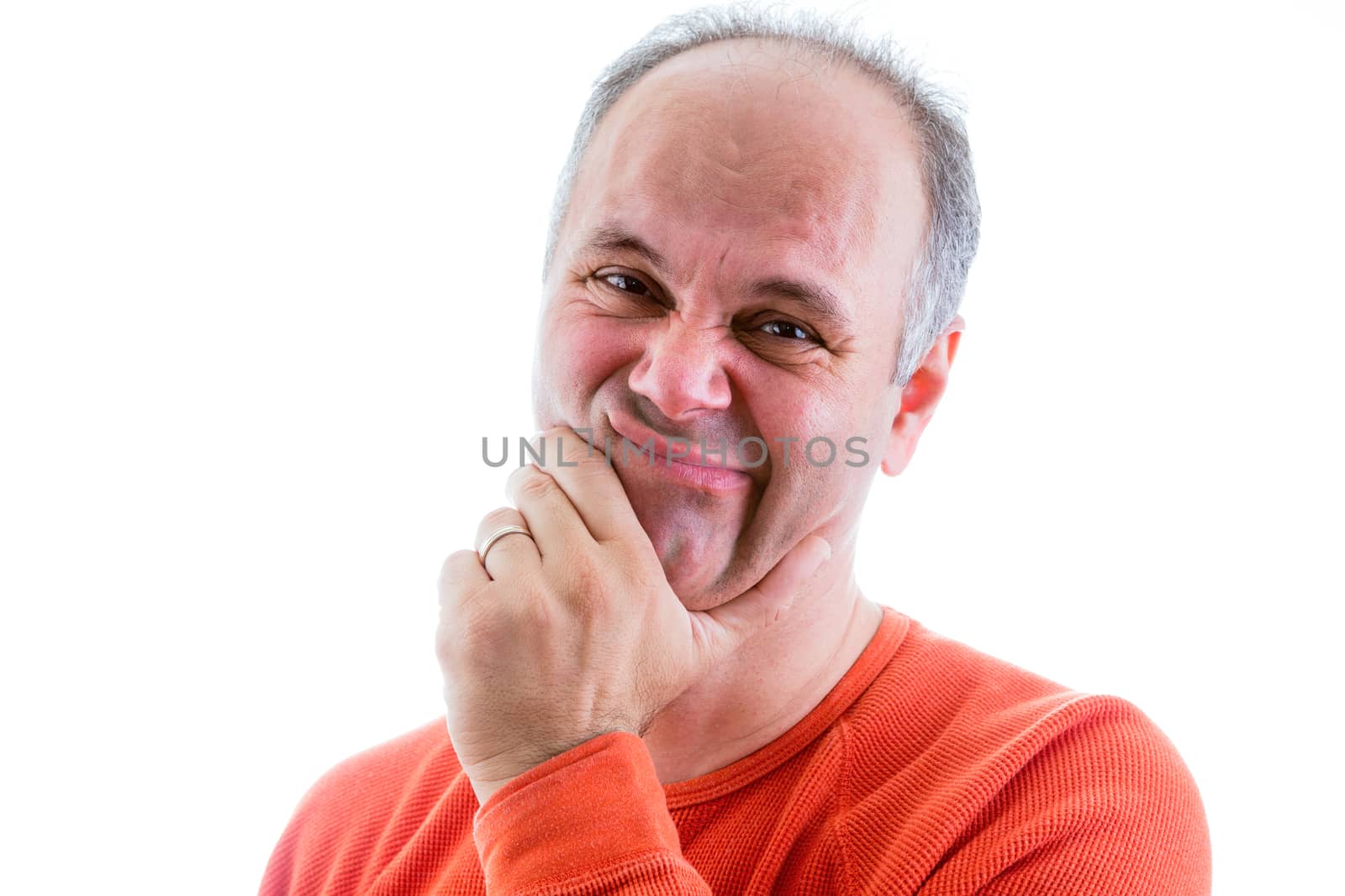 Remorseful middle-aged man with his hand to his chin looking at the camera with a guilt-ridden expression as he regrets his guilt, isolated on white