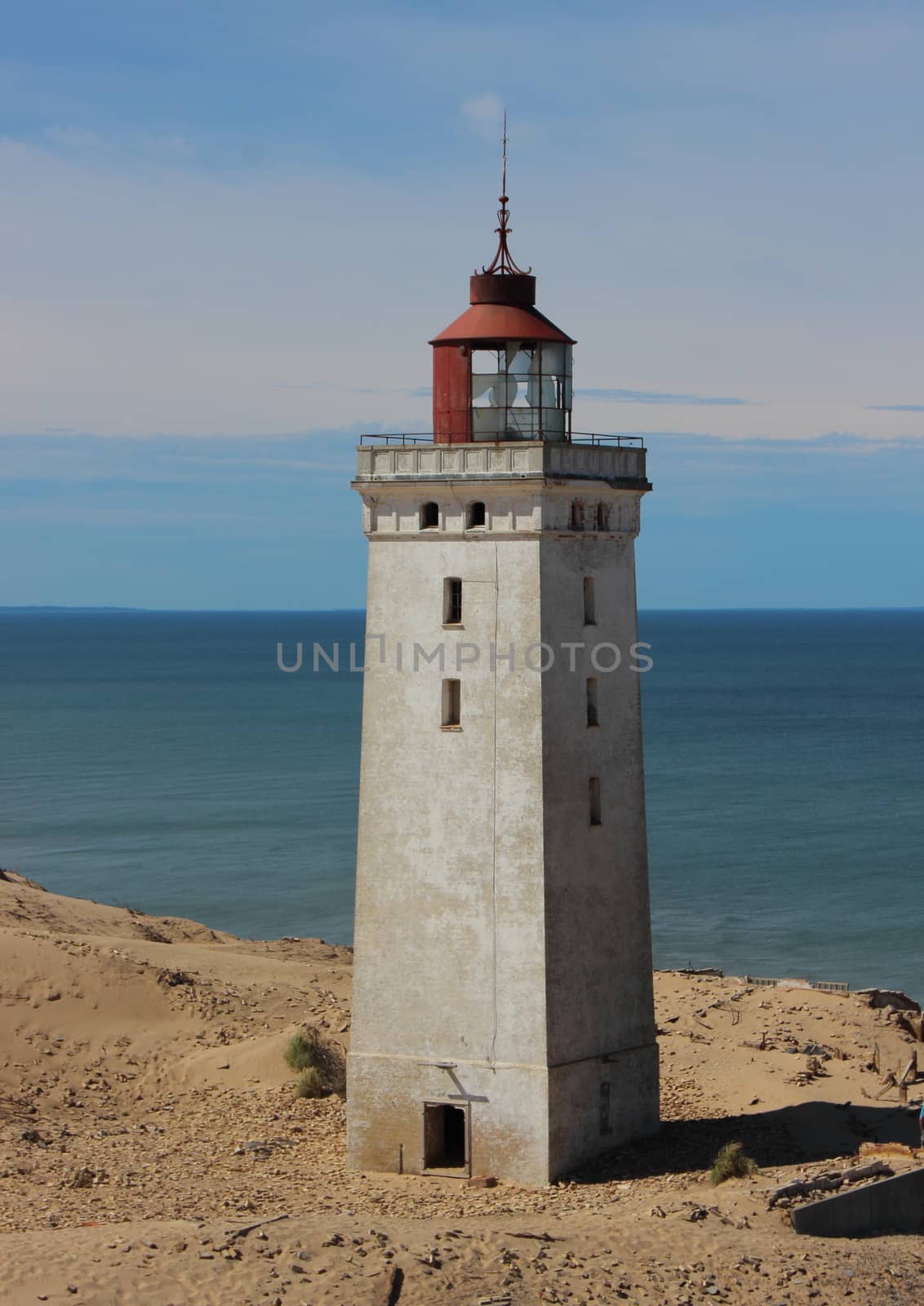 Old Lighthouse at Edge with Ocean in Background