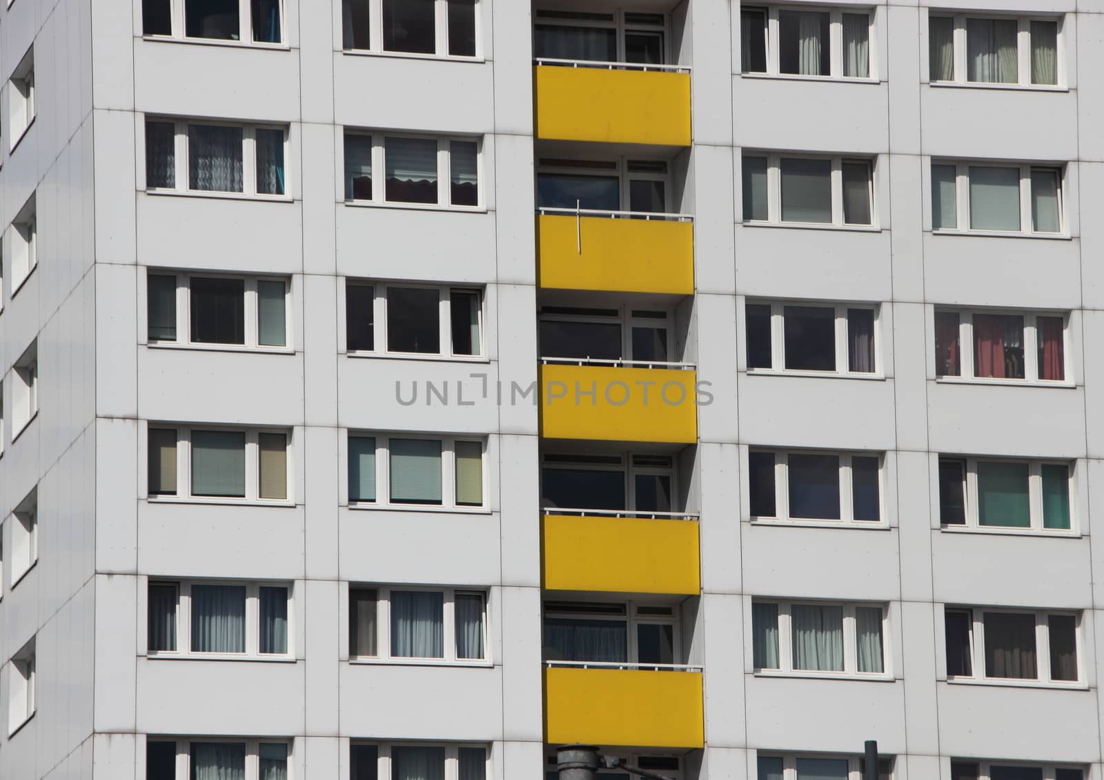 Uniform Apartment Building Facade with Yellow Color Balcony