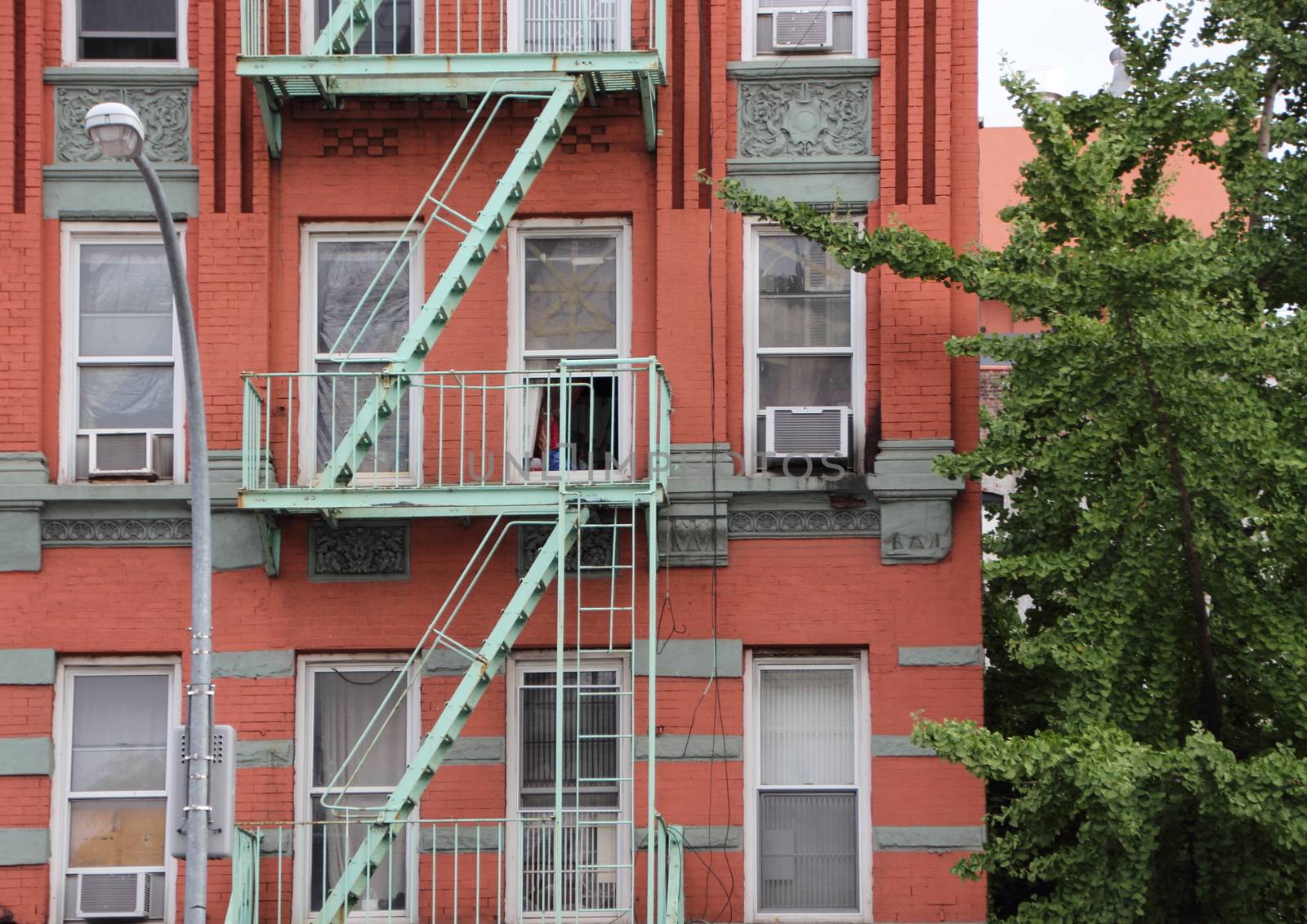 Green Metal Fire Escapes on Old Red Apartment Building in New York