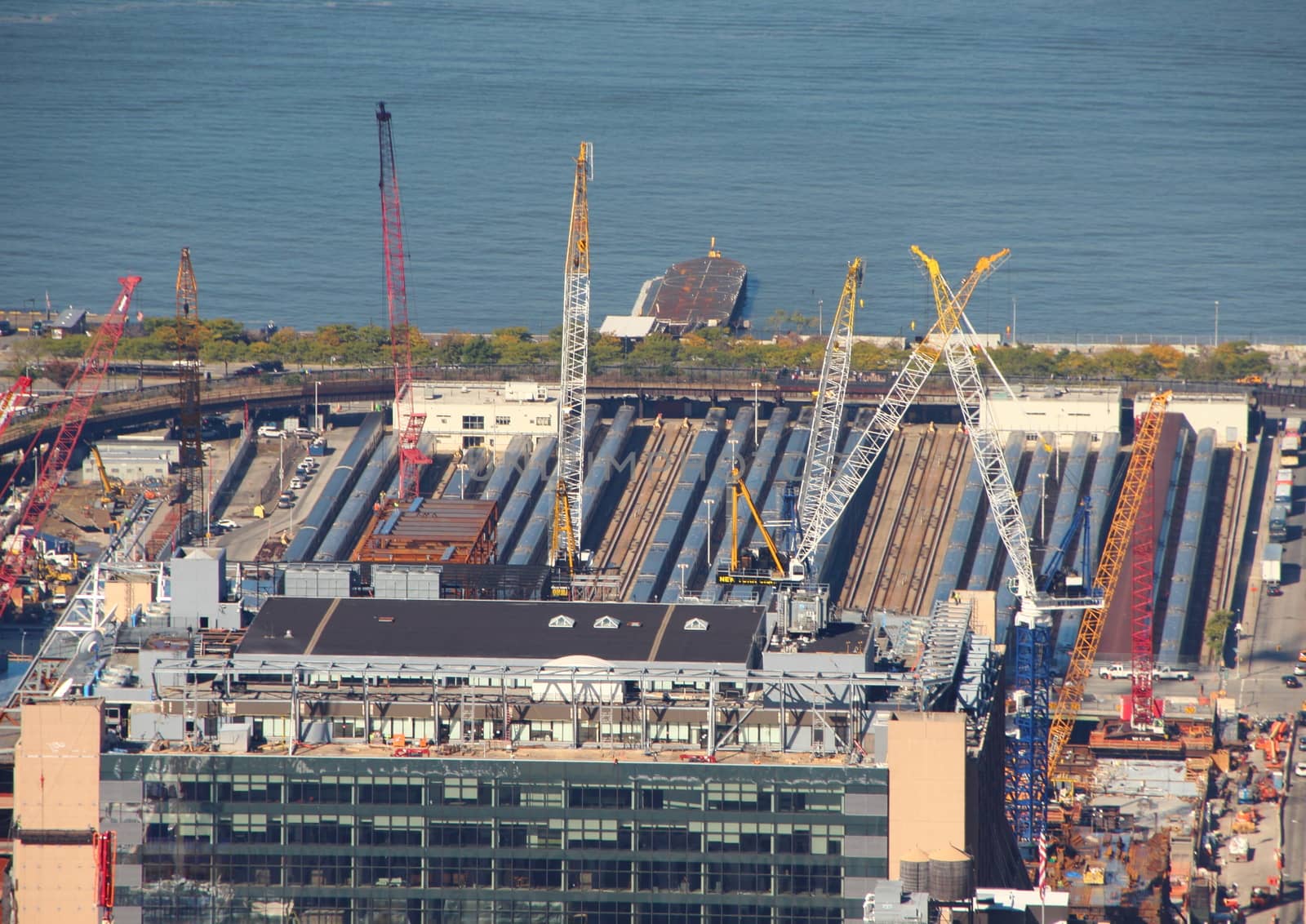 Skyscraper Construction Site with Cranes in Aerial Perspective at Hudson River