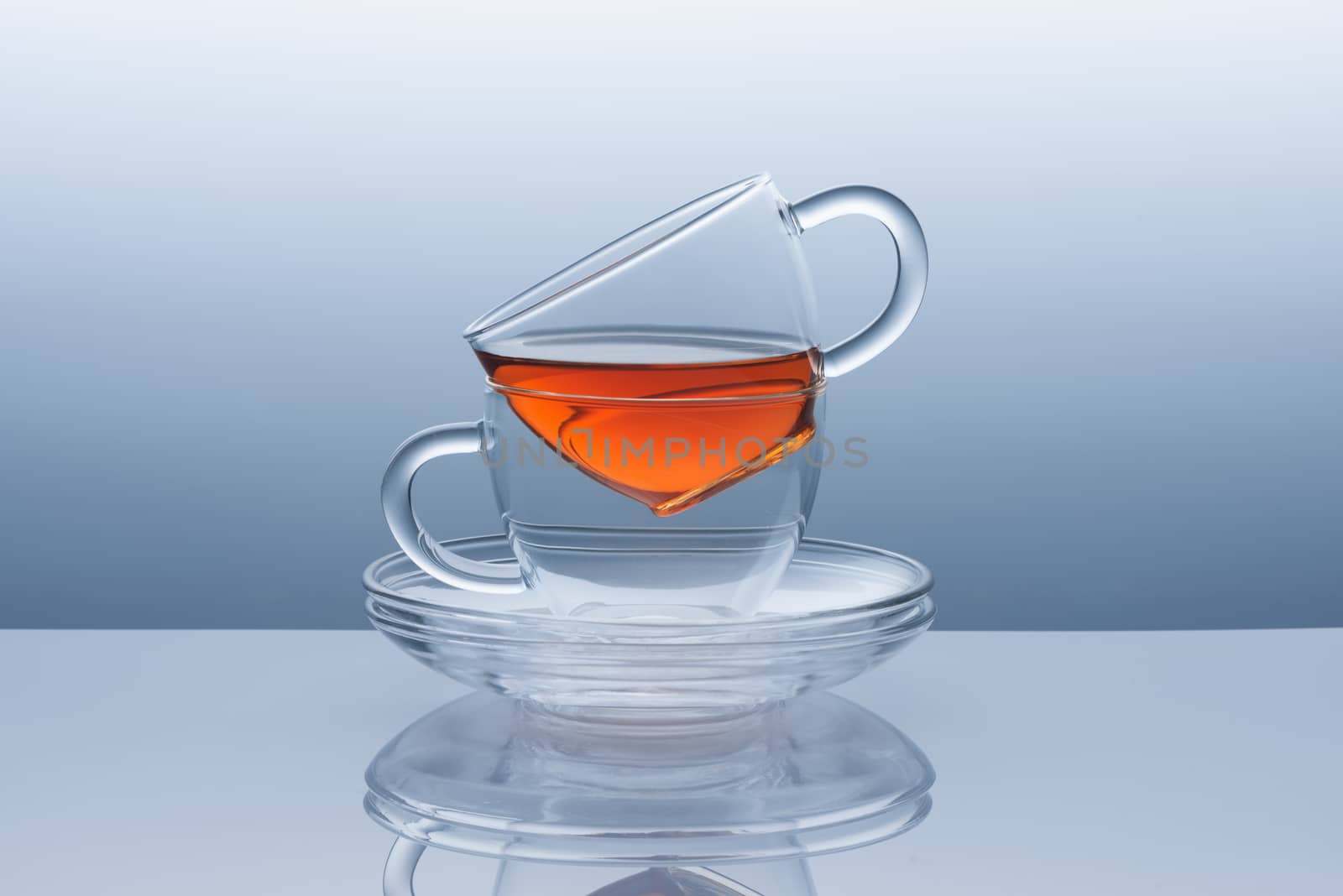 Two cups with saucers from transparent glass from the tea remains