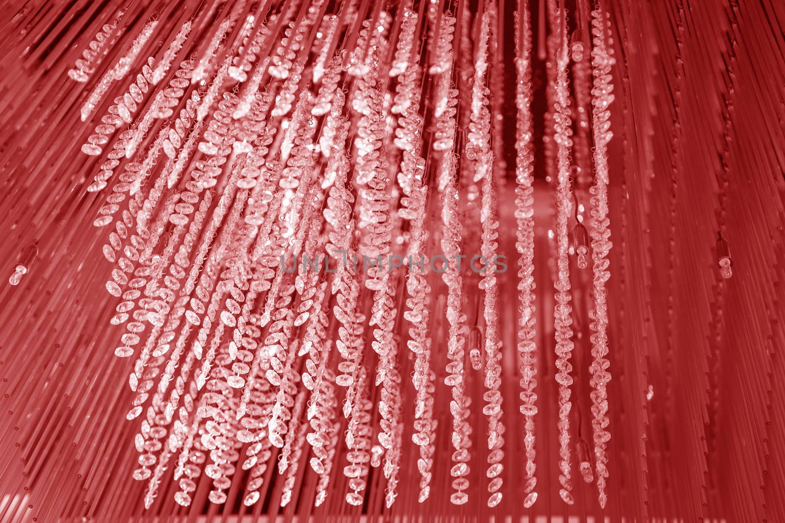 Modern glass chandelier. Decorative red crystal chandelier on the ceiling - interior decoration abstract background. Abstract background texture