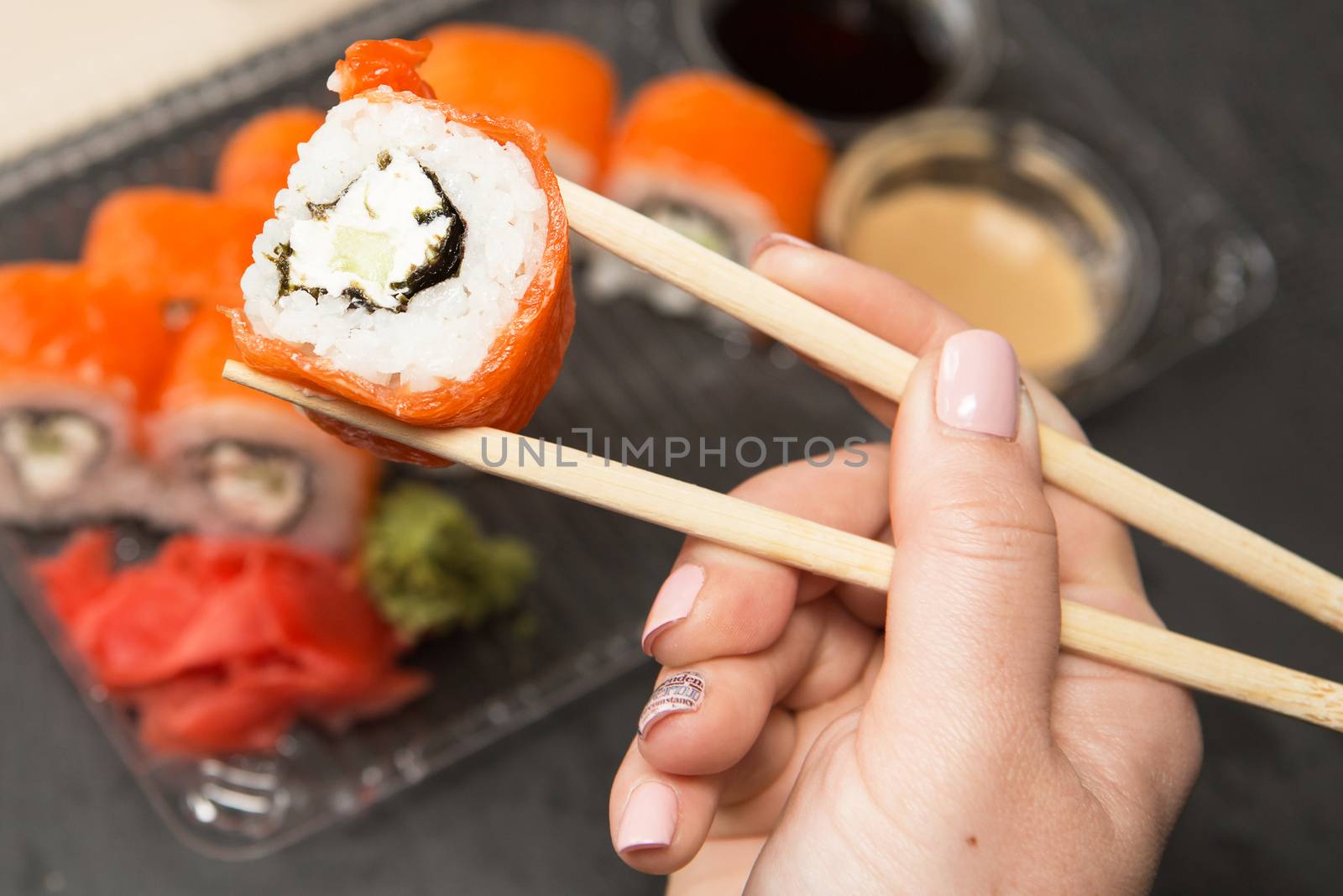 Sushi roll philadelphia. Philadelphia roll in Disposable Plastic Food Container. Business lunch concept