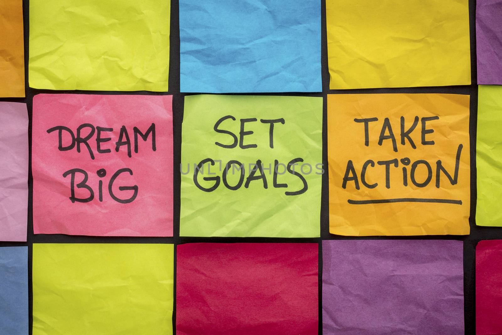 dream big, set goals, take action - motivational advice or reminder on colorful sticky notes