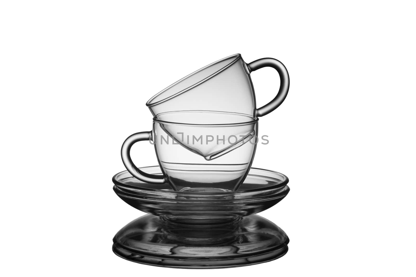 Glass empty cups with saucers for tea isolated on a white background