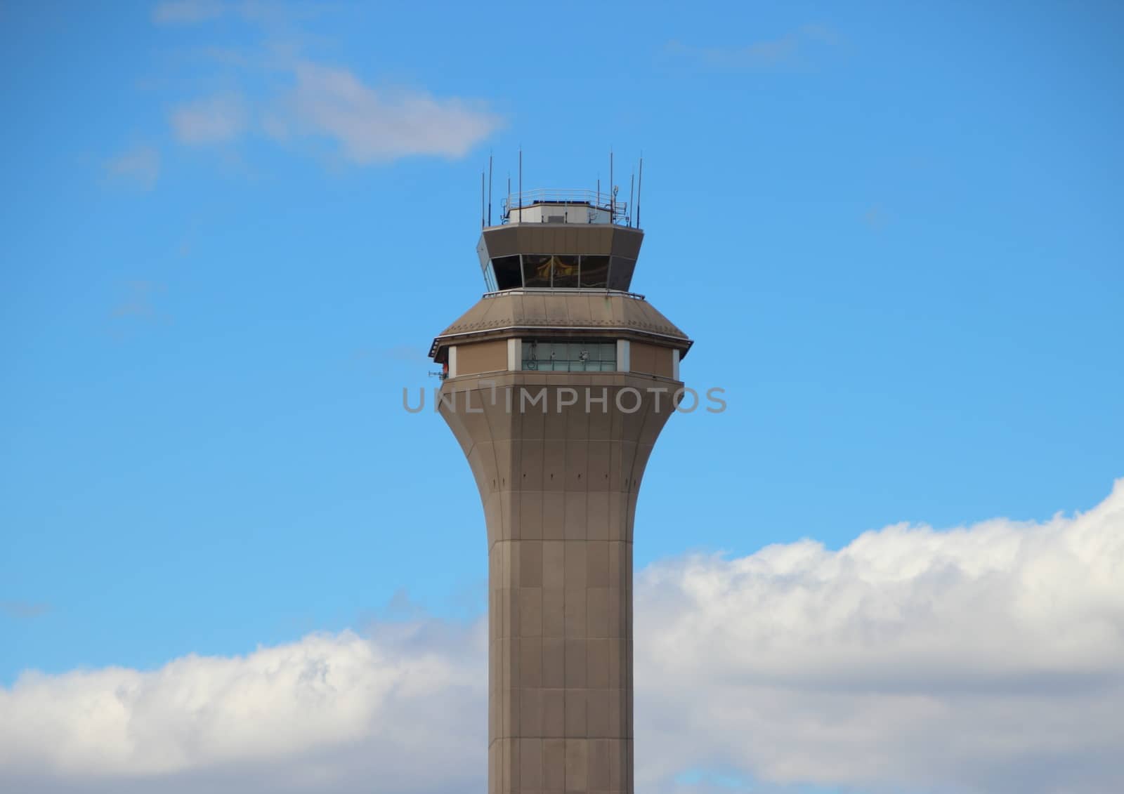 Airport Control Tower with Clouds and Blue Sky by HoleInTheBox