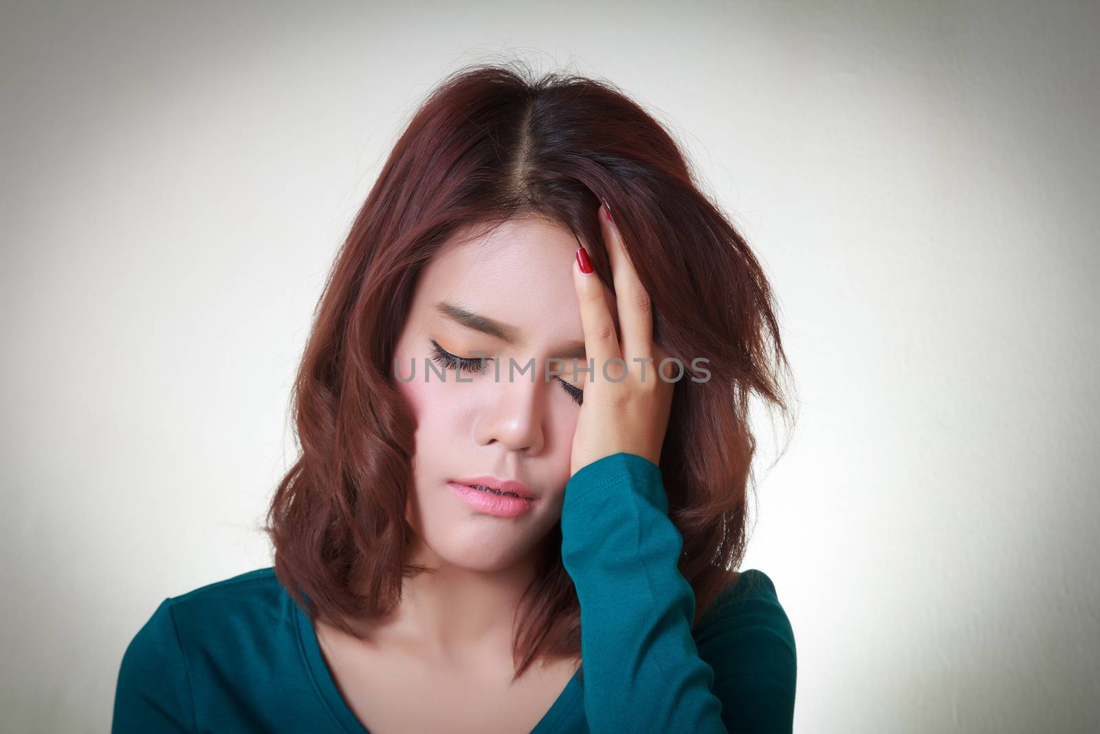 Headache. Young asian woman having a headache