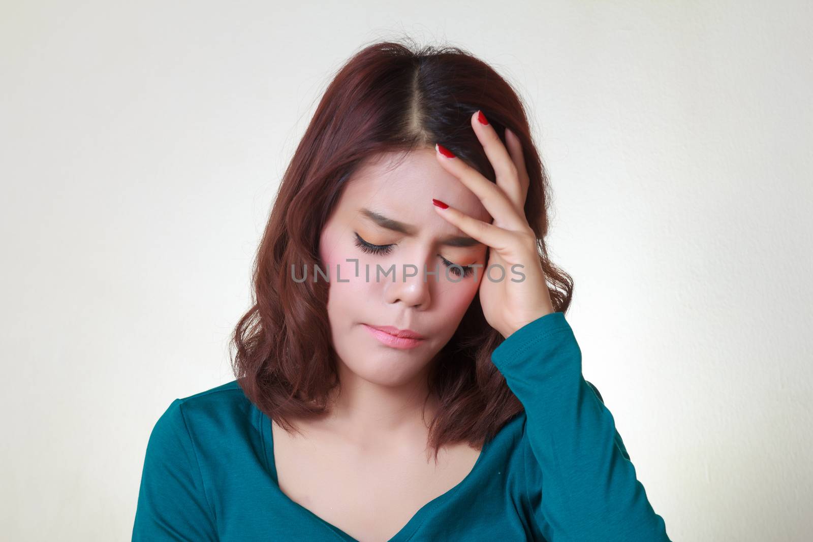 Headache. Young asian woman having a headache