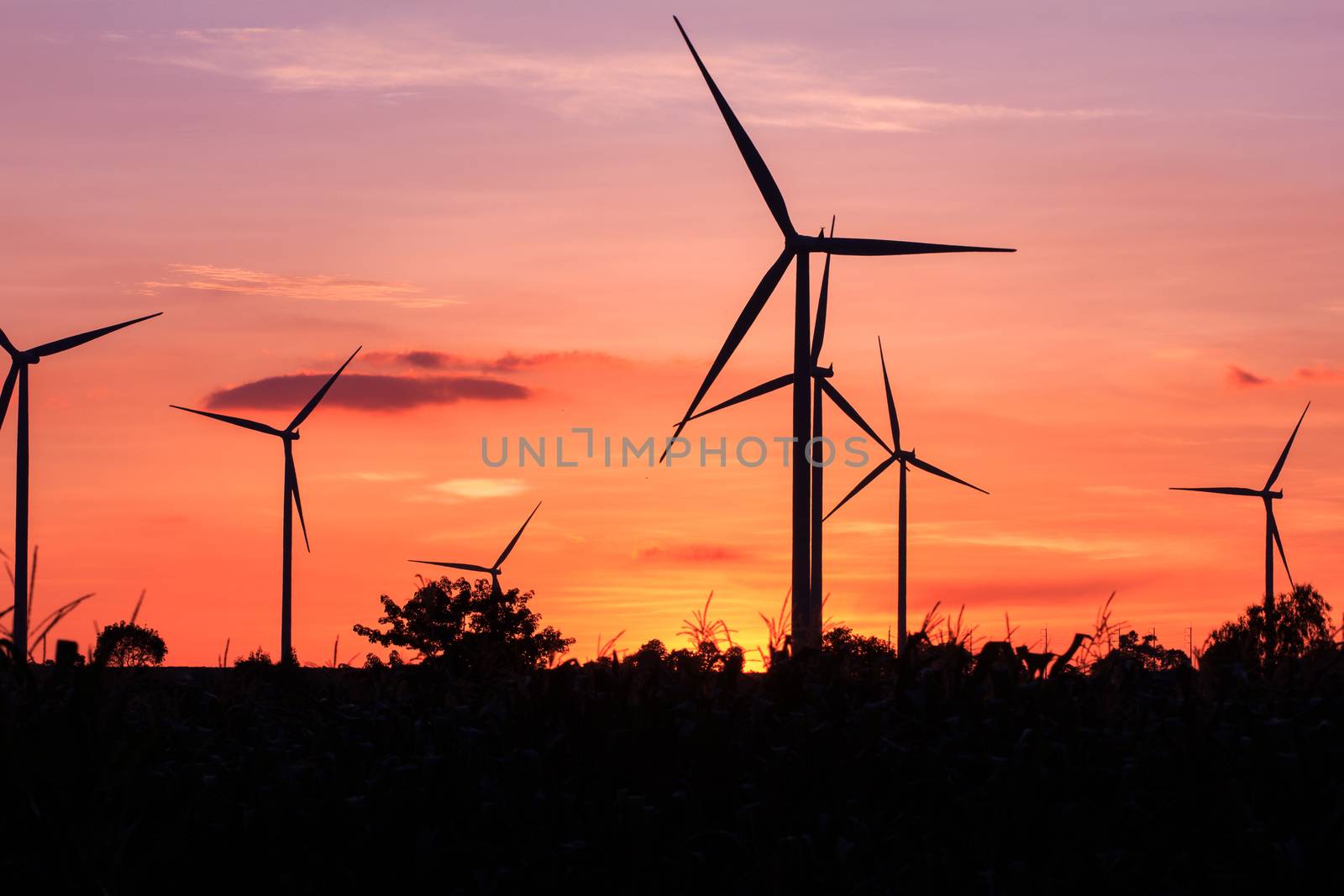 Wind turbine power generator at twilight sunset