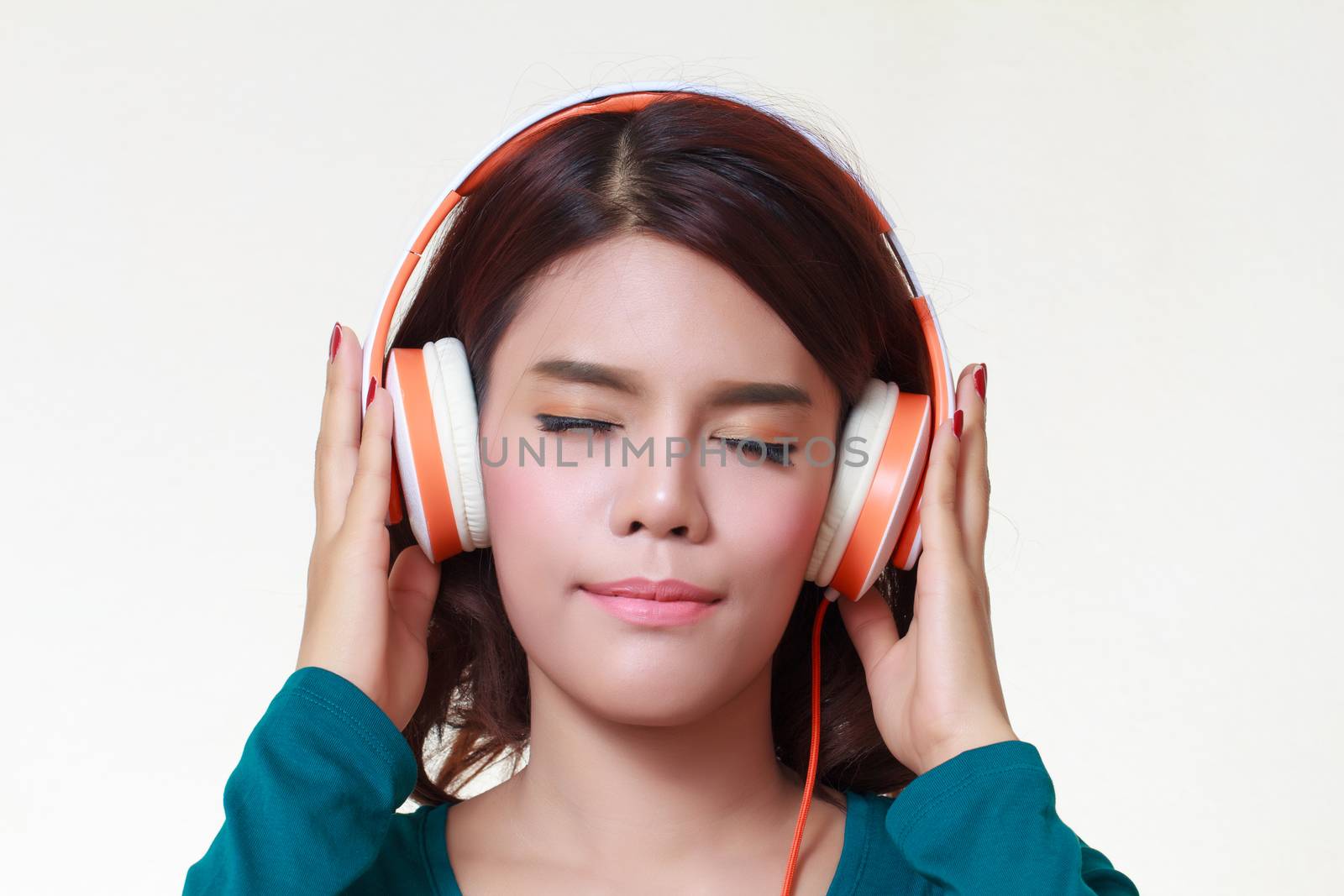 Beautiful young woman with headphones listening to the music