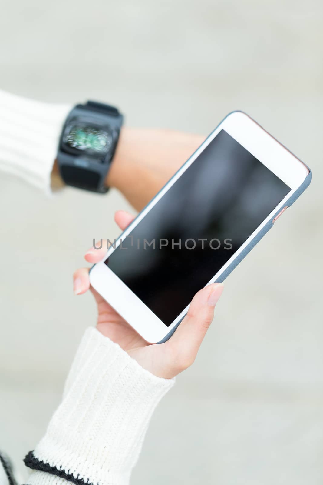 Woman use of smartwatch and cellphone