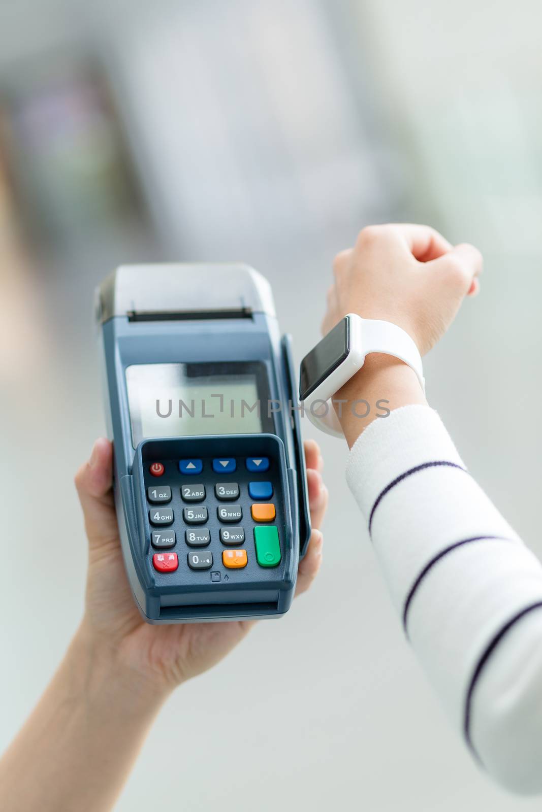 Woman using smartwatch for pay the bill