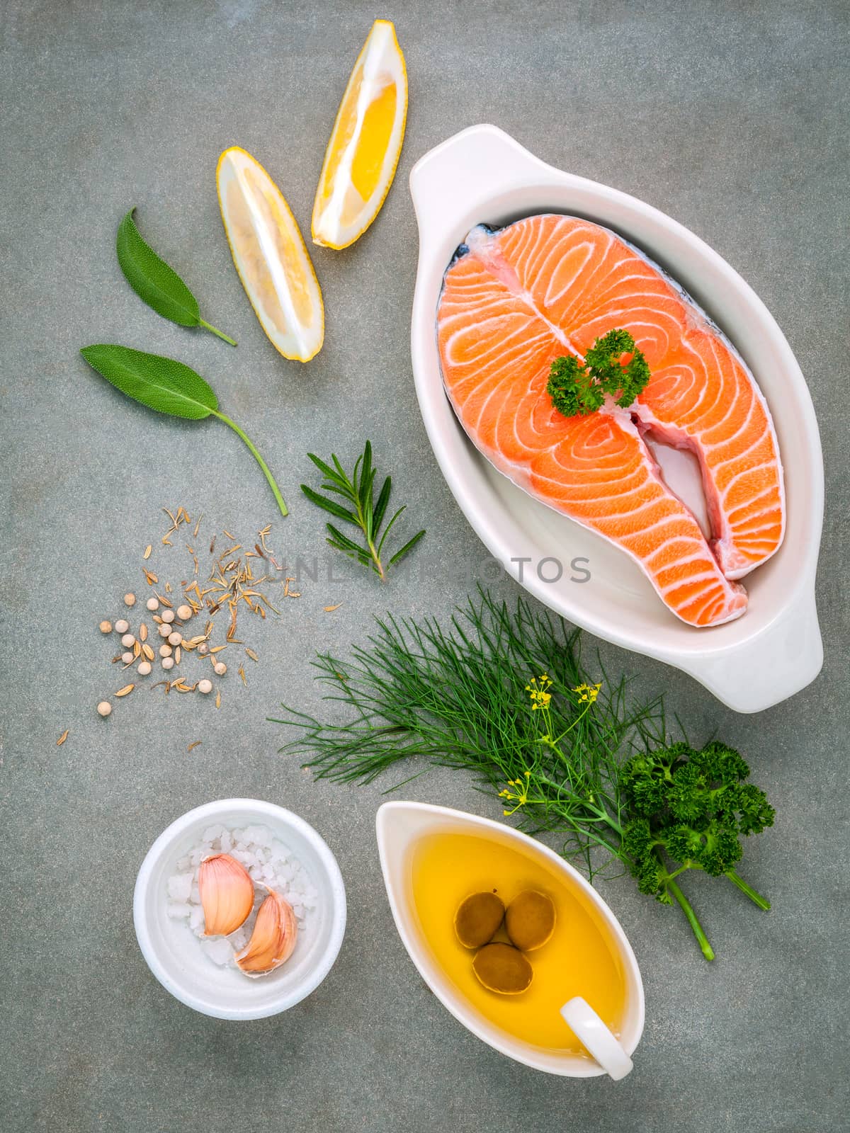 Raw salmon fillet in the white bowl with ingredients olive oil , by kerdkanno