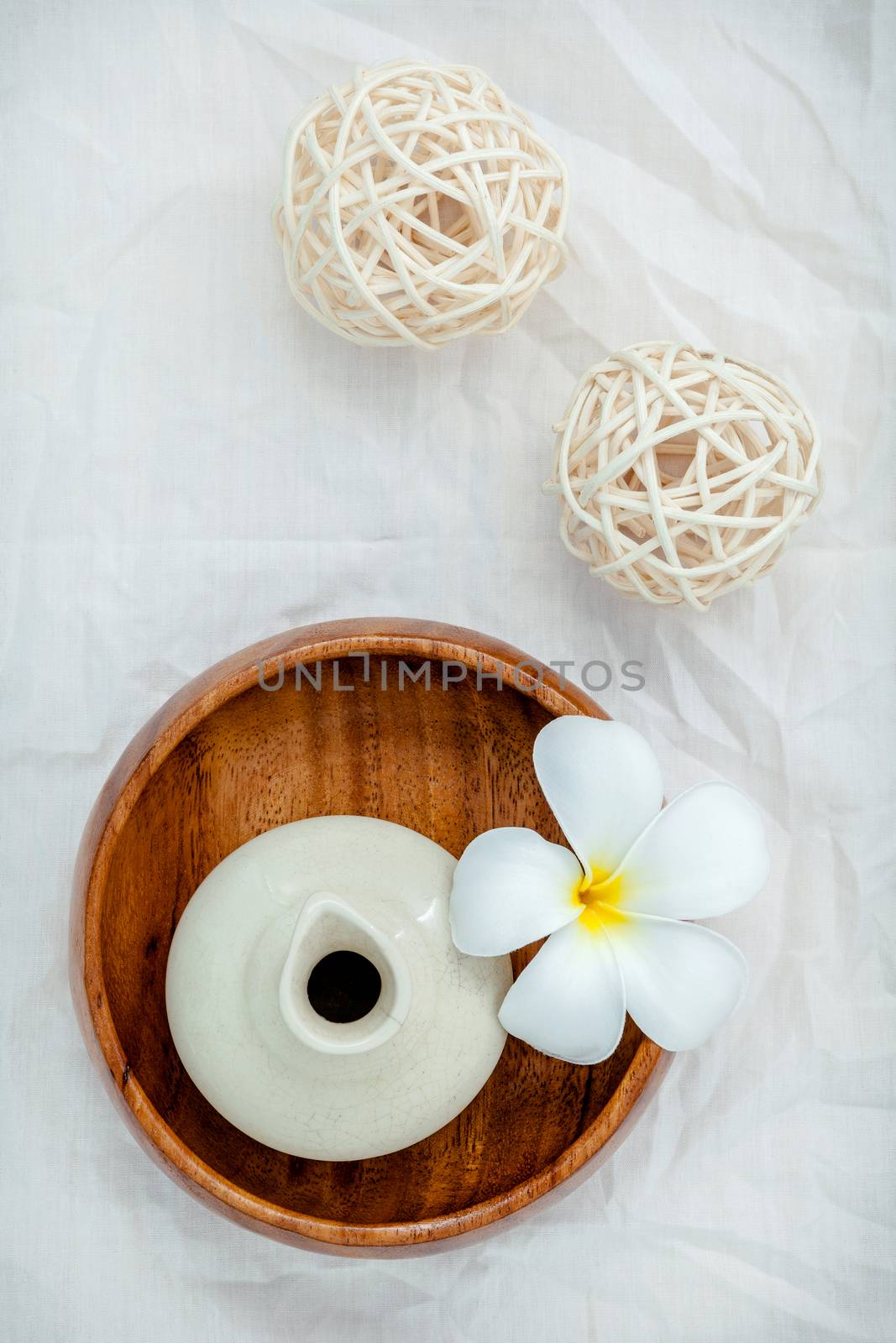 Frangipani tropical flowers with herbal spa products . Plumeria flowers with aromatic oil . Thai spa theme aromatherapy  with herbal. Relaxation with herbal essential oil.