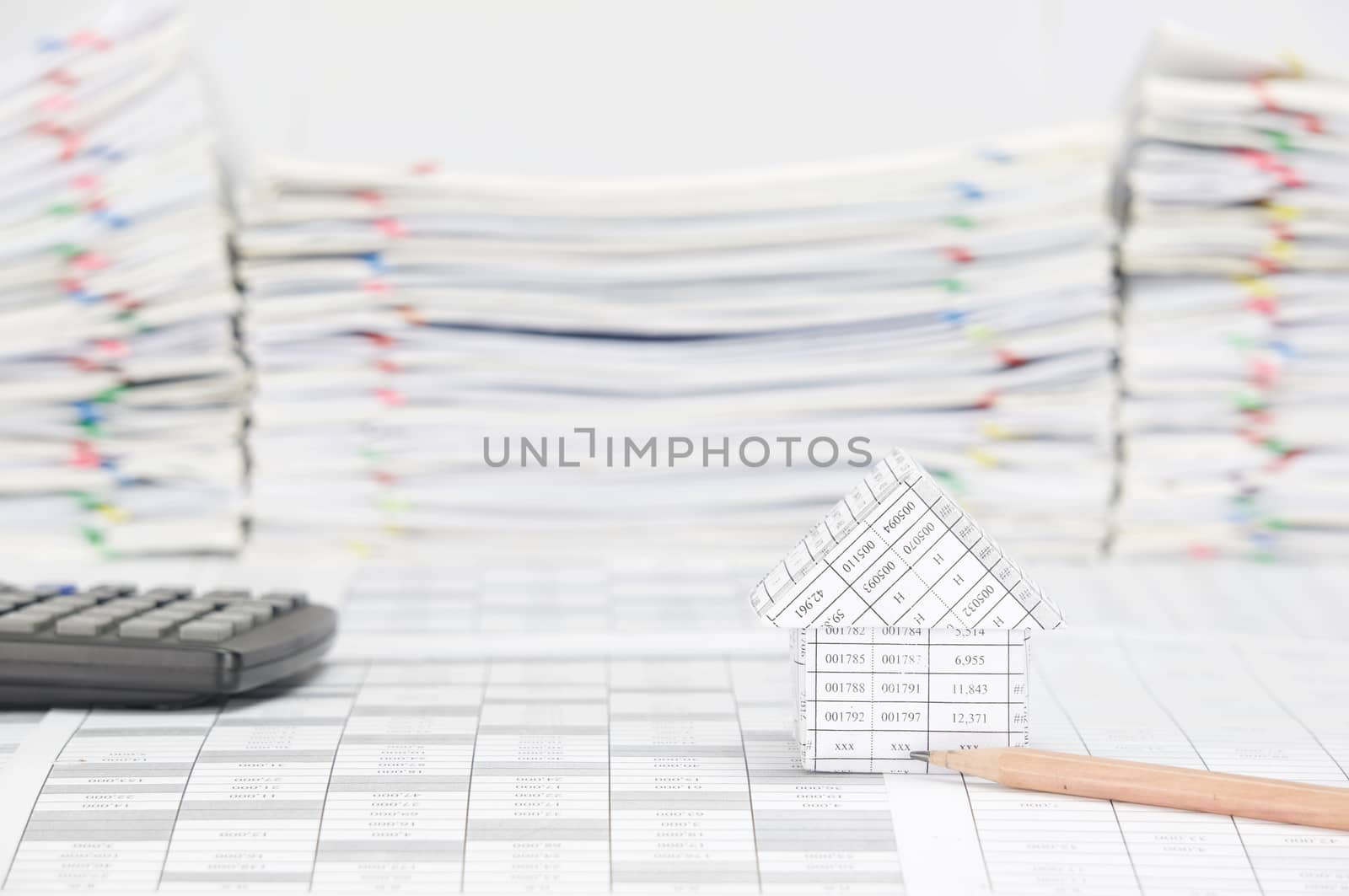 House with pencil have blur calculator and paperwork as background by eaglesky