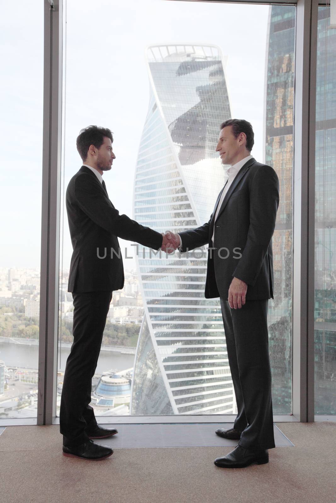 Business people shaking hands, finishing up a meeting in office