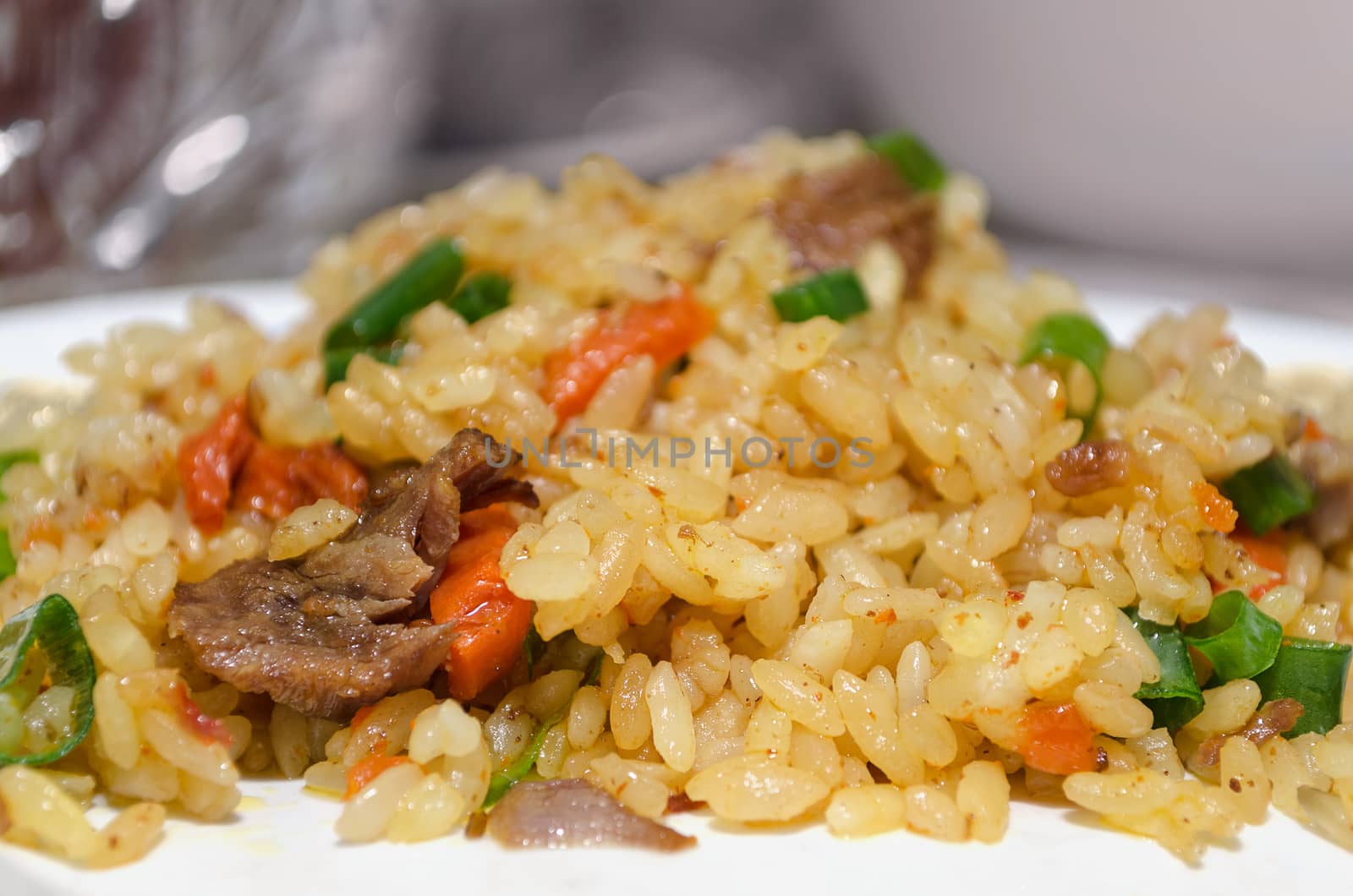 Uzbek pilaf on a platter, close-up and bokeh