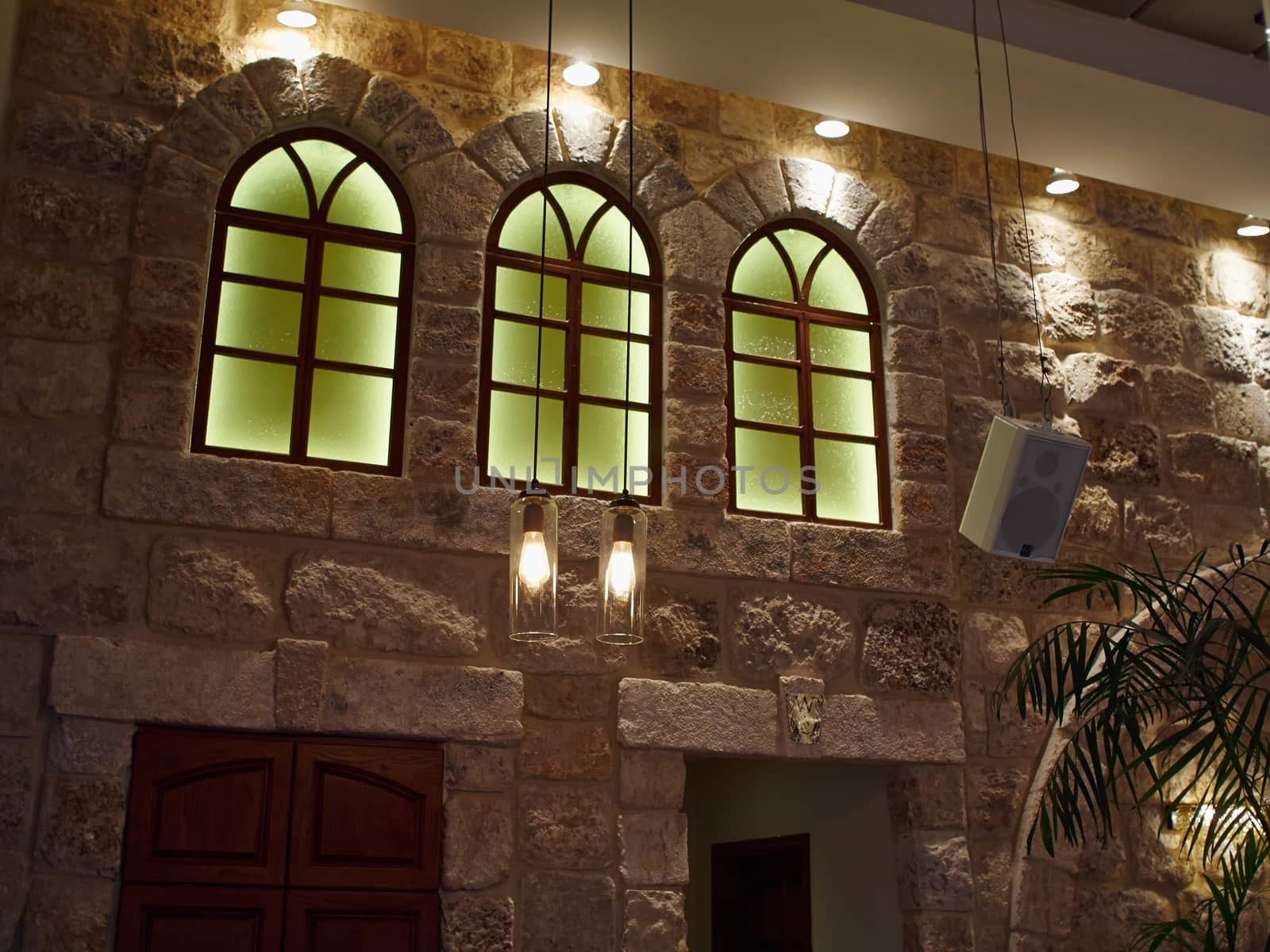 Decorative handmade stone wall with modern lamps for great indoors atmosphere