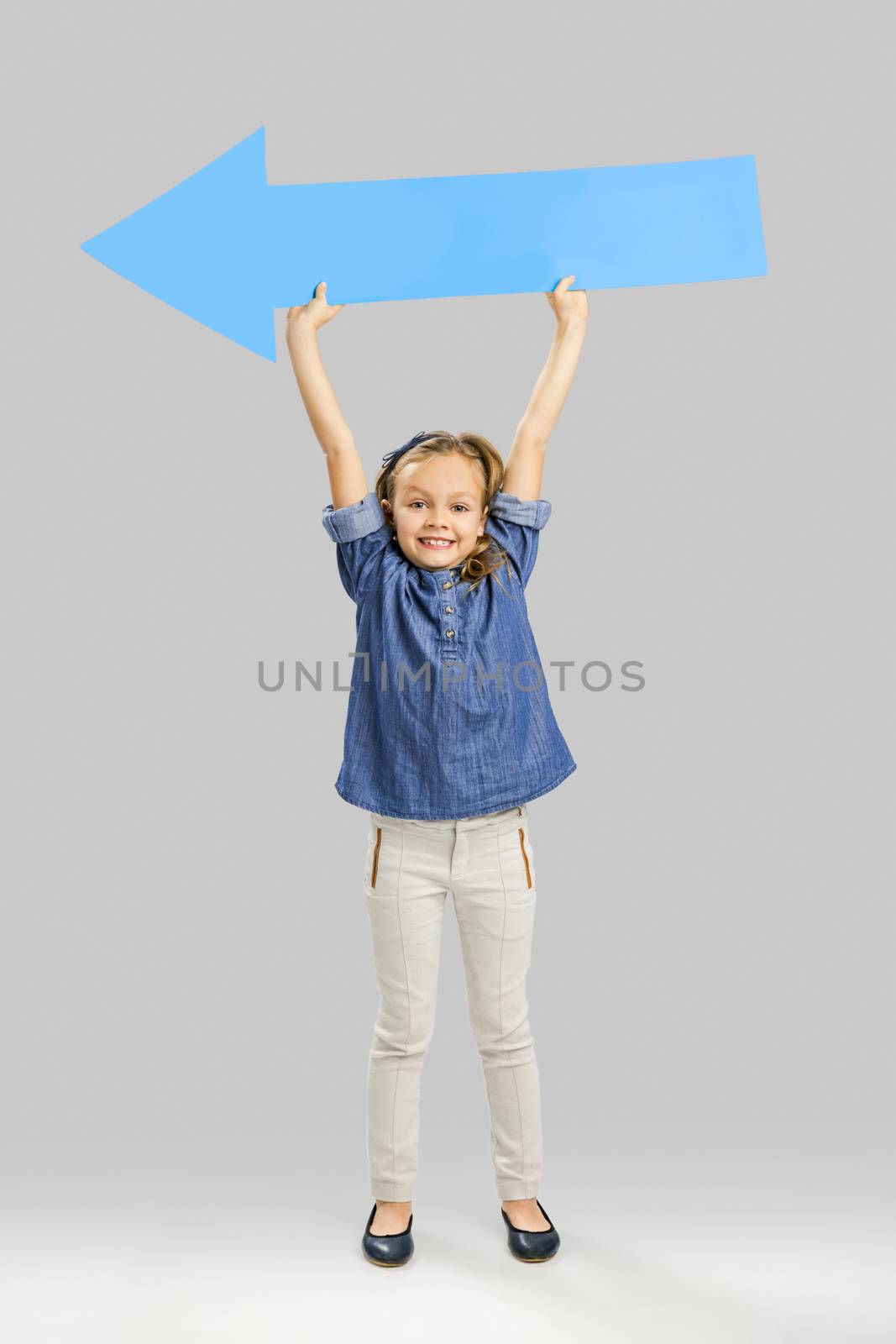 Beautiful little girl holding a arrow card