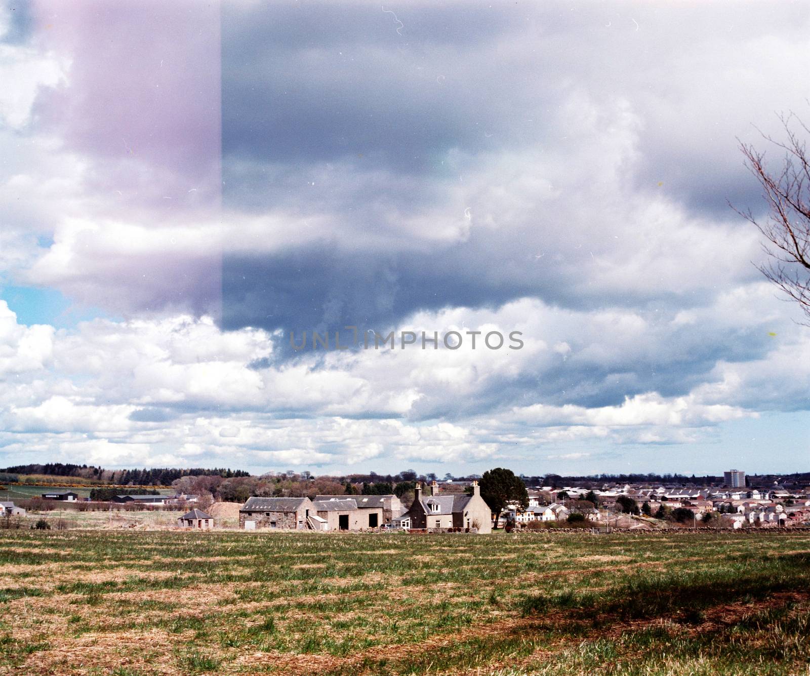 Film image of a village seen from a field in Hazelhead, Aberdeen