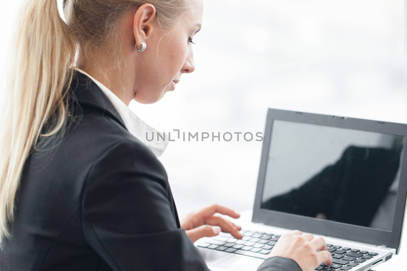 Business woman working with laptop close up view