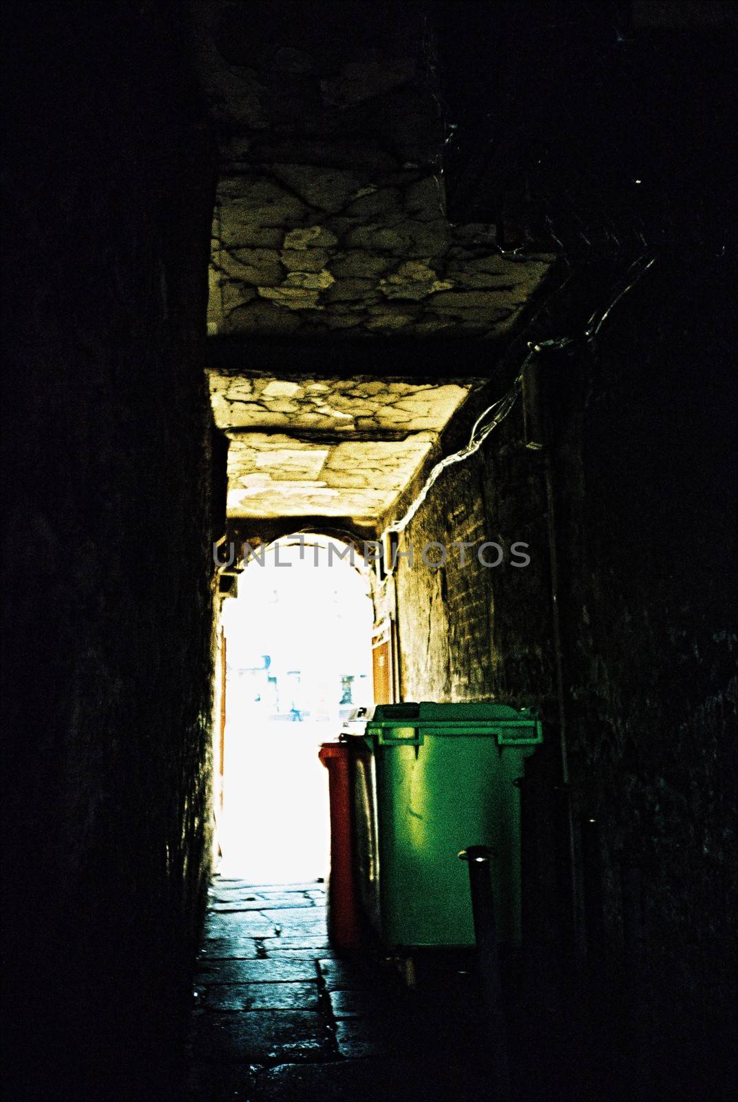 Garbage bins in gangway on a cobblestone street in Aberdeen