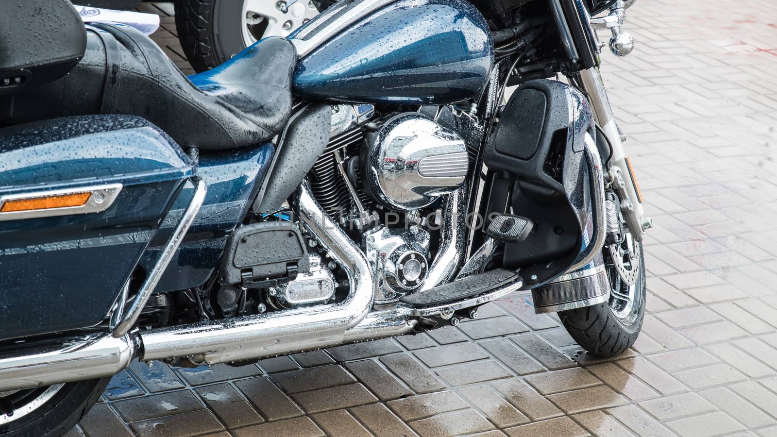 Blue classic motorcycle at parking in the rain