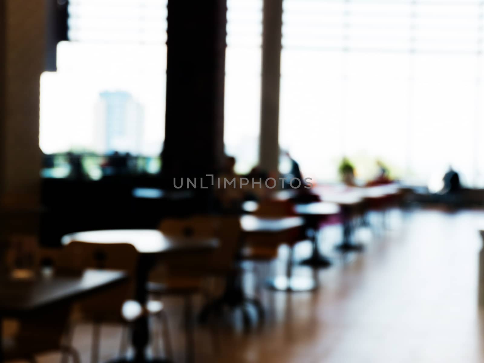 Silhouettes of people sitting in a cafe. Specially blurred photo