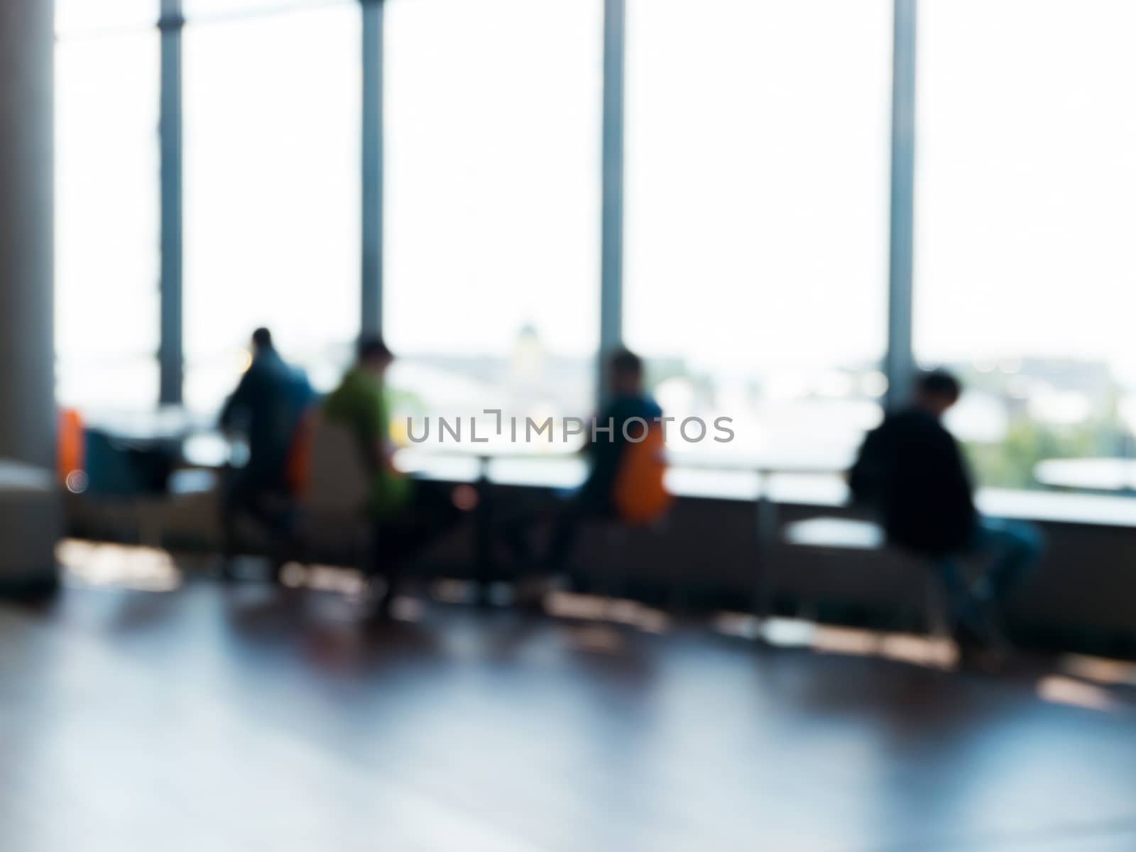 Blurred silhouettes of people sitting in a cafe. by fascinadora