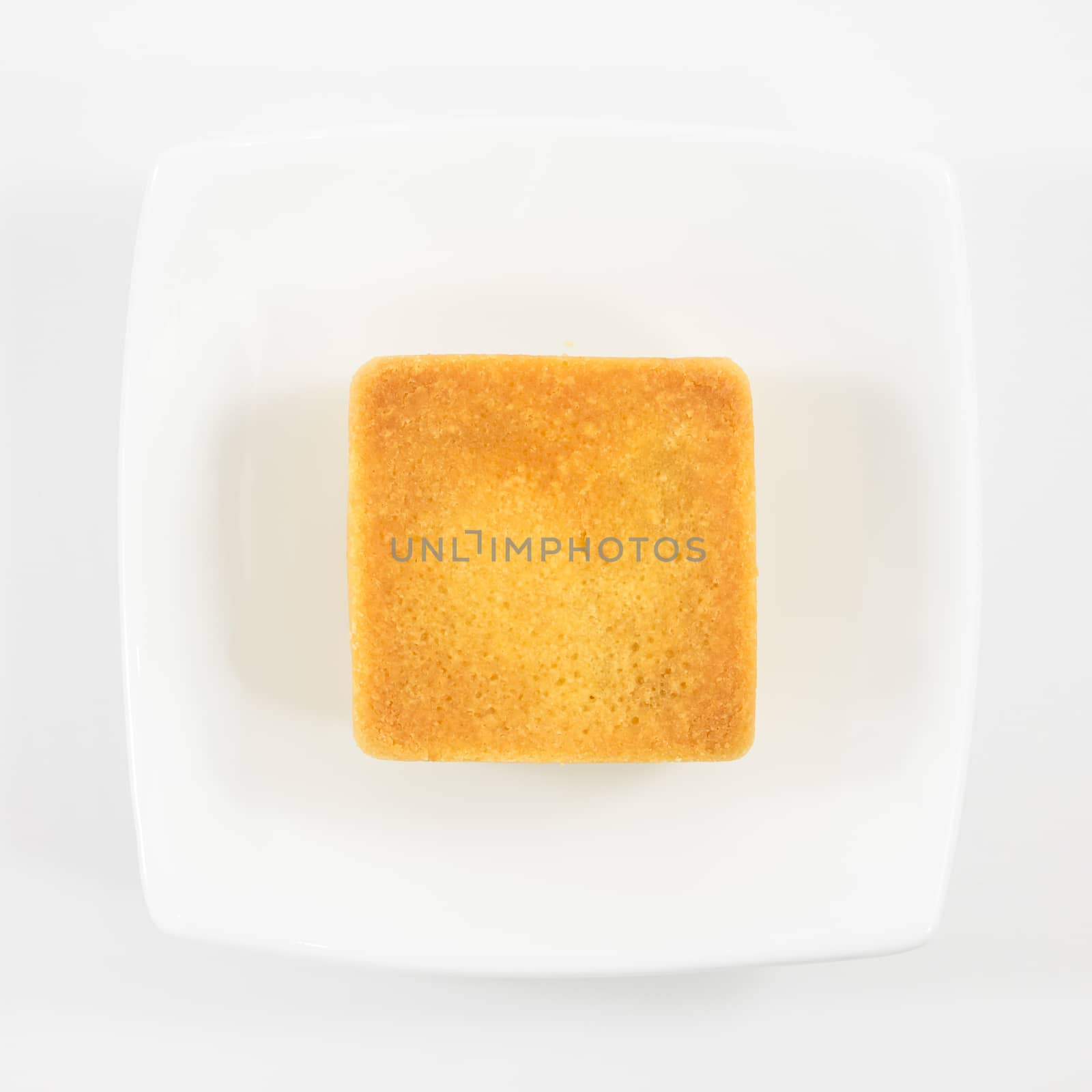 The tasty Taiwanese pineapple pastry cake on the small white square dish.