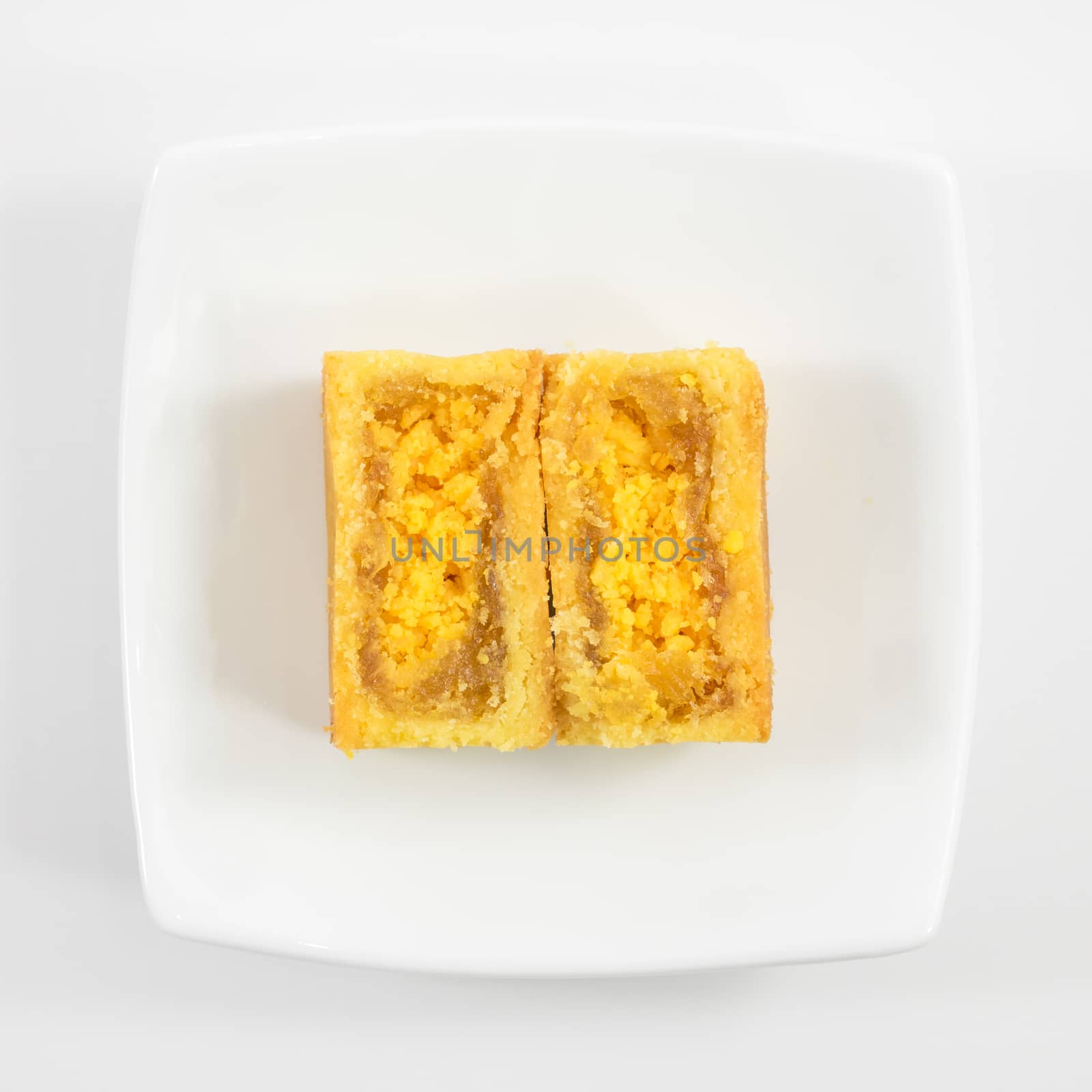 The tasty Taiwanese pineapple pastry cake on the small white square dish.