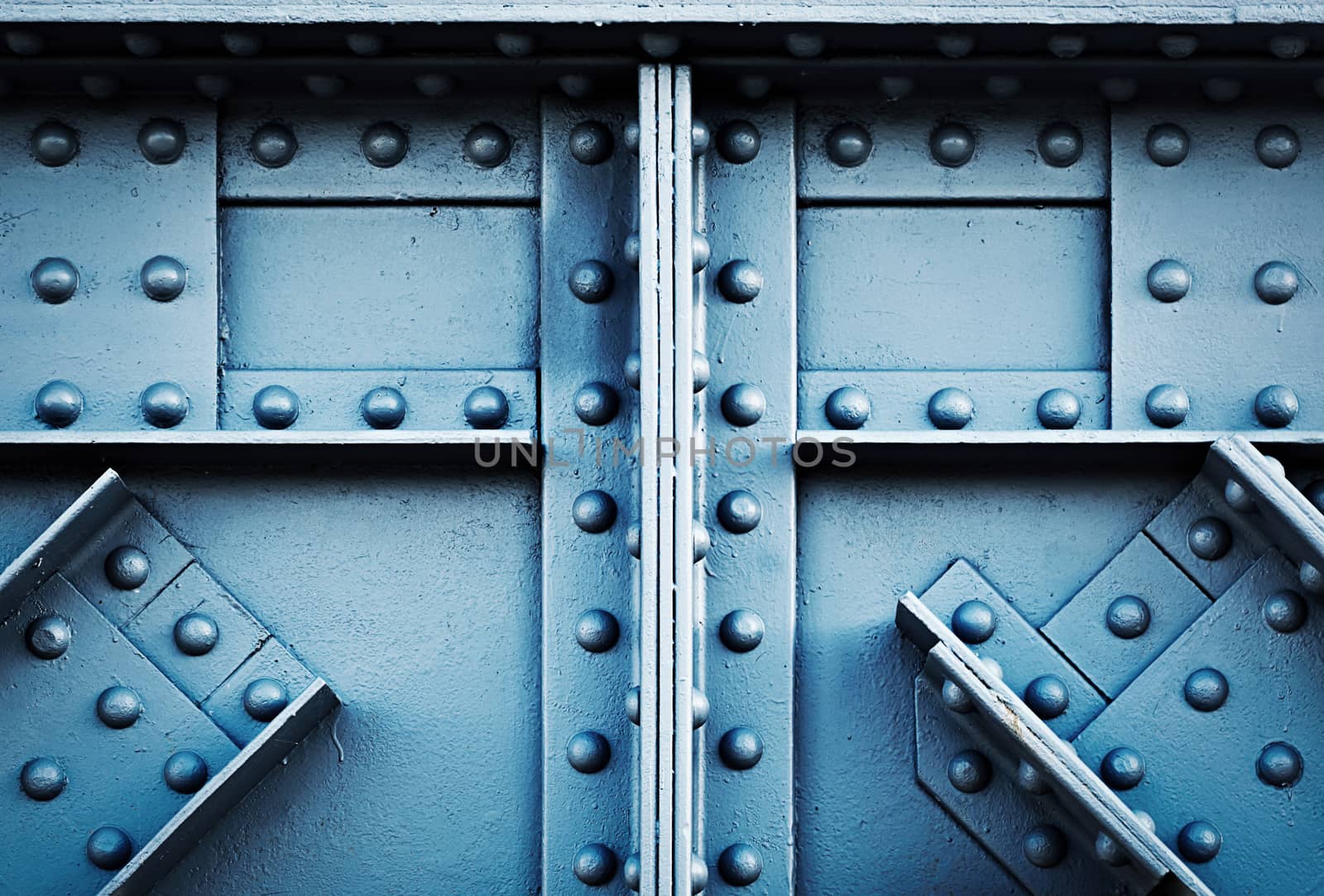 background or texture detail blue silver riveted girder railway bridge