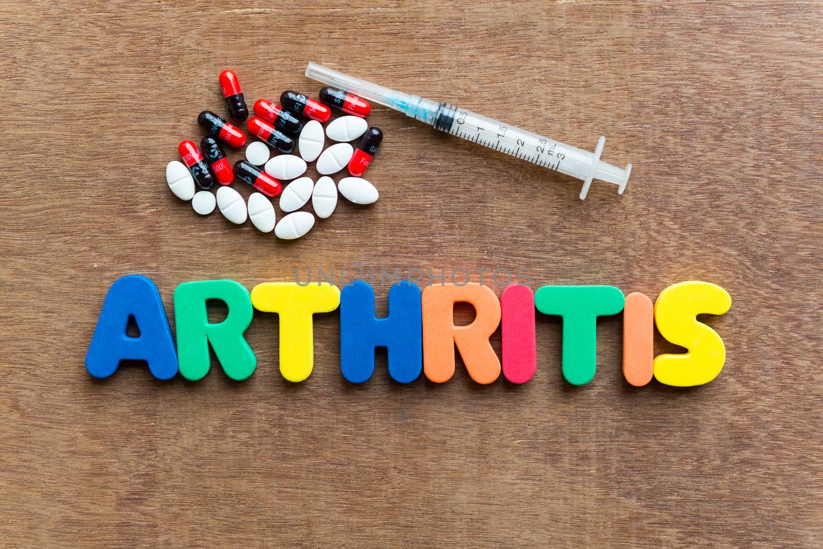 arthritis colorful word in the wooden background