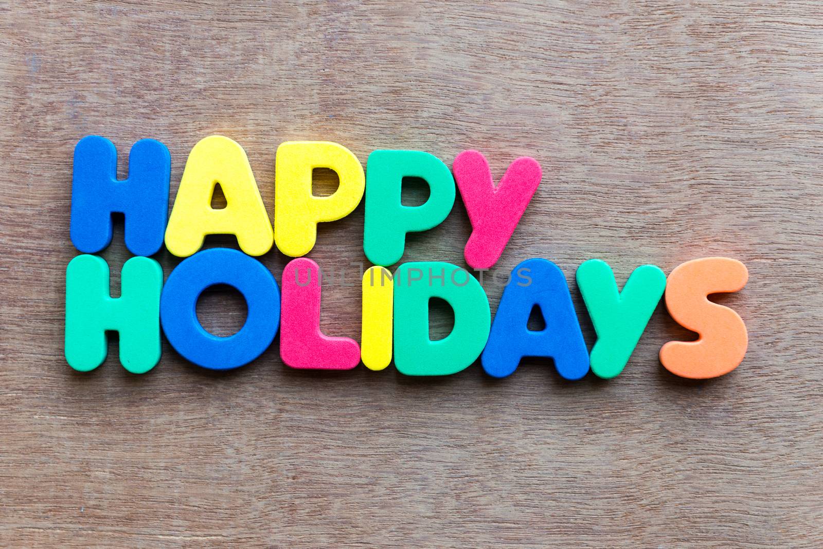 happy holidays words in wood background