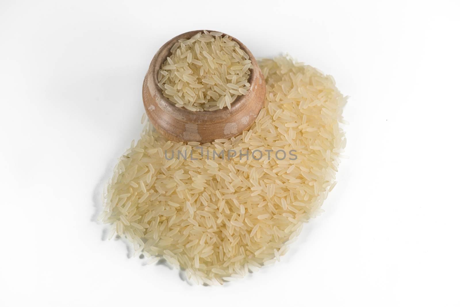 Rice in a wooden bowl on white background