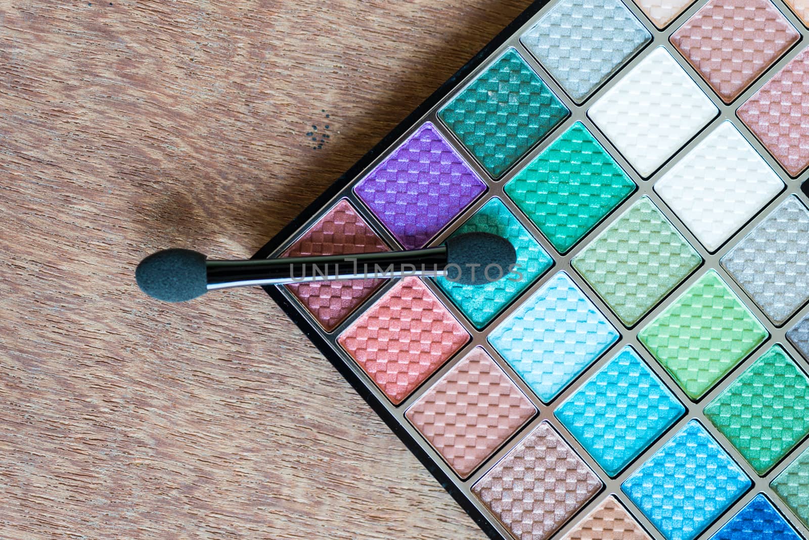 colorful Eyeshadow palette on the wooden background