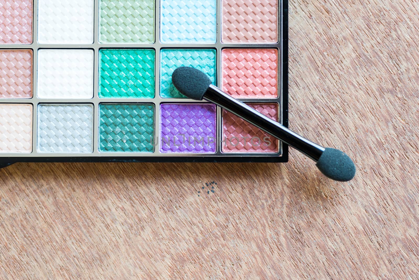 colorful Eyeshadow palette on the wooden background