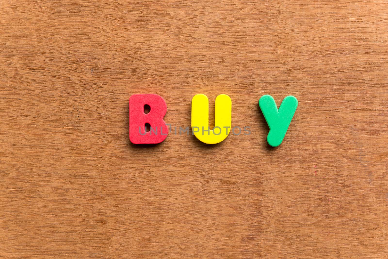 buy colorful word on the wooden background