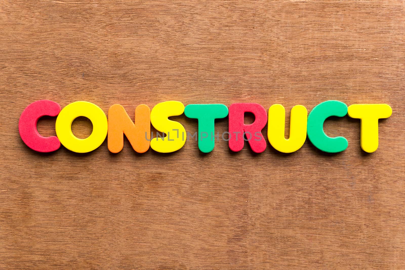 construct colorful word on the wooden background